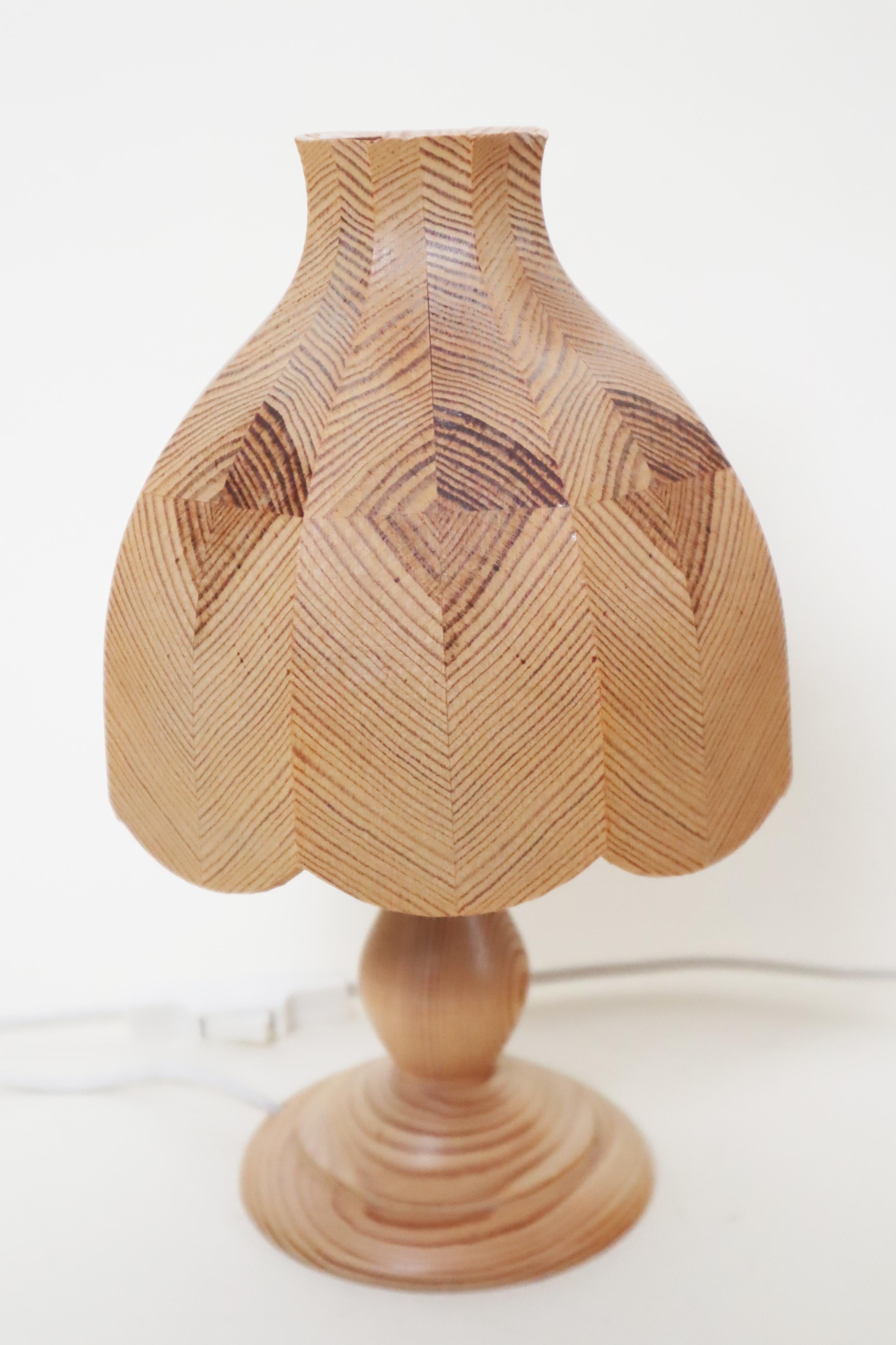 This beautiful, rare set of two Swedish table lamps with pinewood shades is naturally stunning. The pinewood lamp base, with its warm wood tone, is a work of art. The lampshade, assembled with exquisite craftsmanship, is a small masterpiece. Light