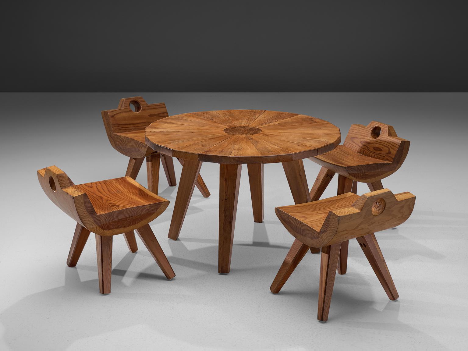 Set of stools and table, solid pine, Sweden, 1960s.

This Swedish set of small chairs with the round table is made of solid pine. The round shapes in combination with the angular tapered legs give this set a certain playfulness. This dining set