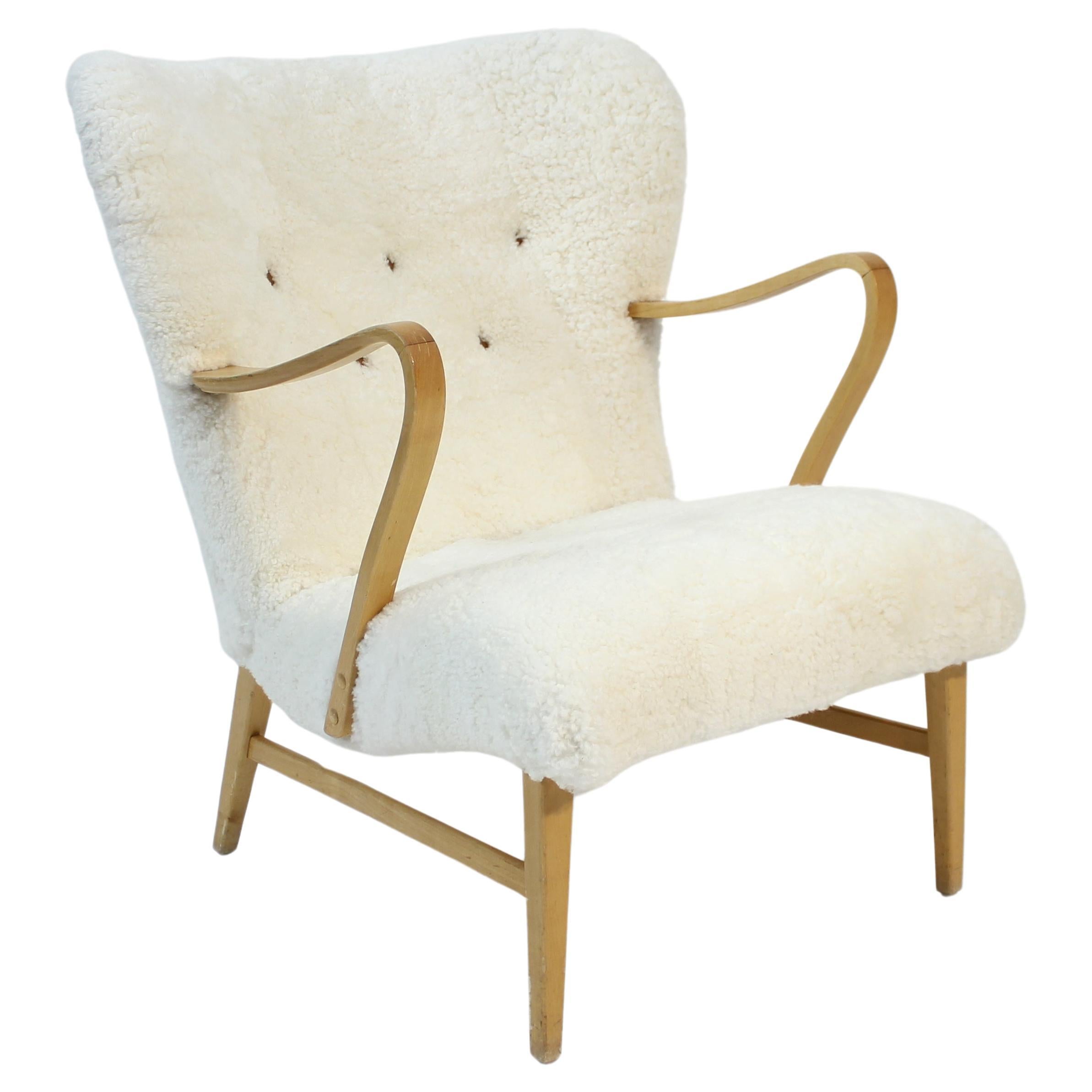 Swedish sheepskin lounge chair, attributed to Erik Bertil Karlén, 1940s For Sale