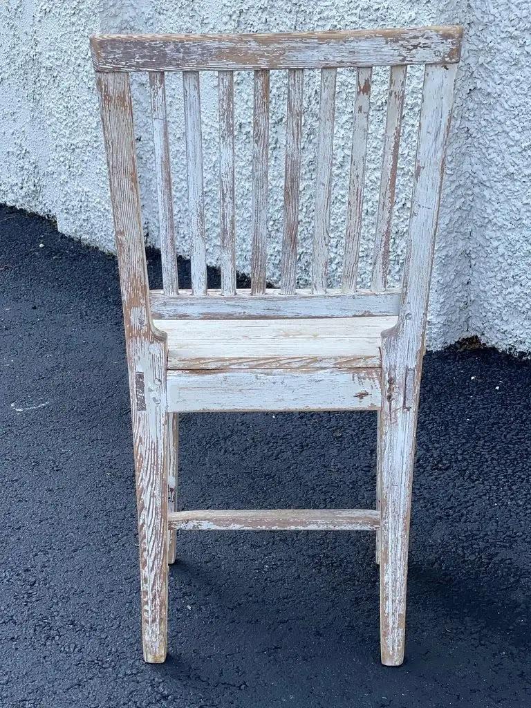 Rare set of four 19th century Swedish side chairs, original off white paint, each having slat backs with reeding and old light-blue polychrome. Pegged construction, the square seats over tapered and reeded legs connected by an H stretcher. Measures: