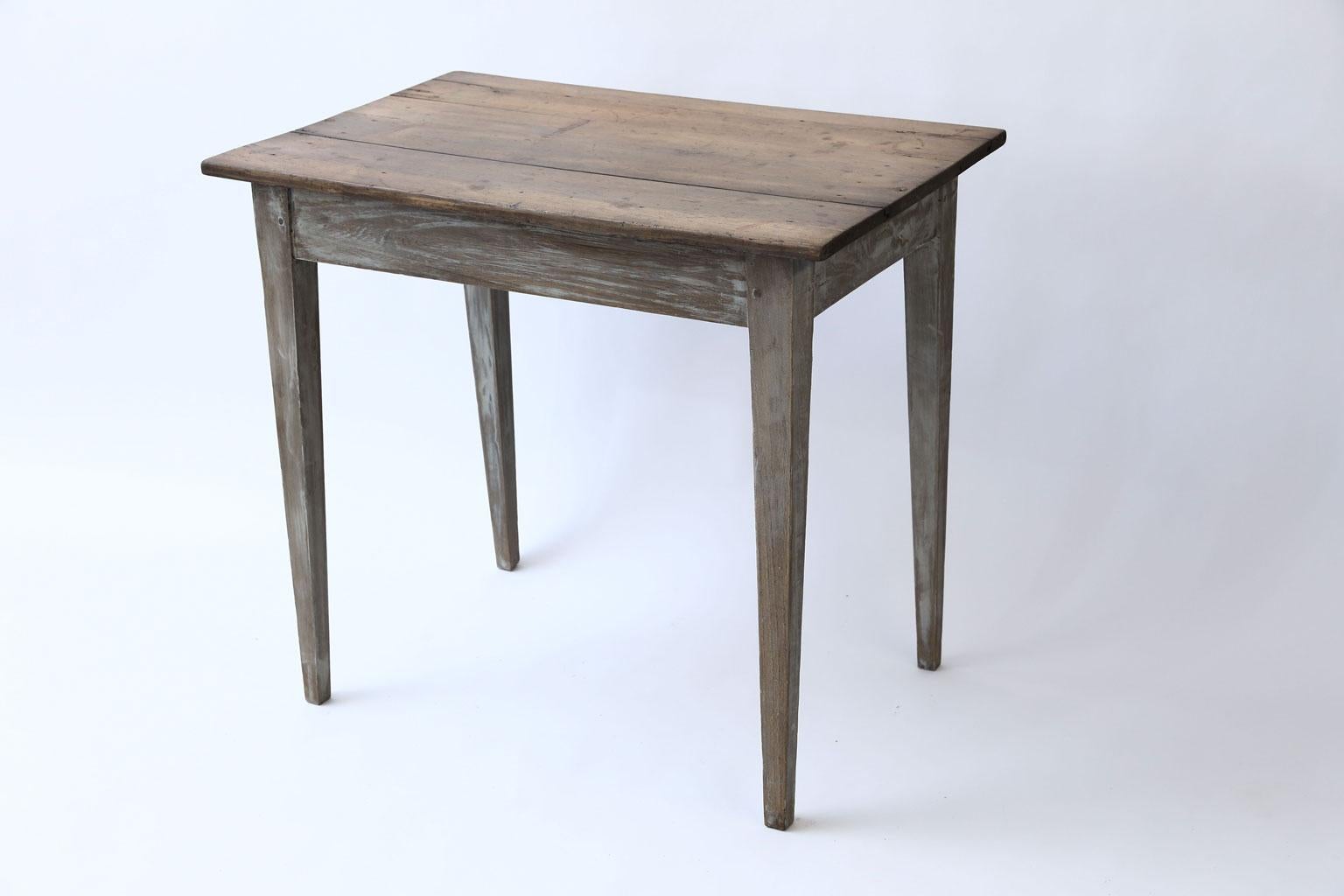 Swedish side table (circa 1840-1860), scrubbed and waxed top raised upon tapered leg base. Mortise and Tenon construction. Remnants of paint on base.