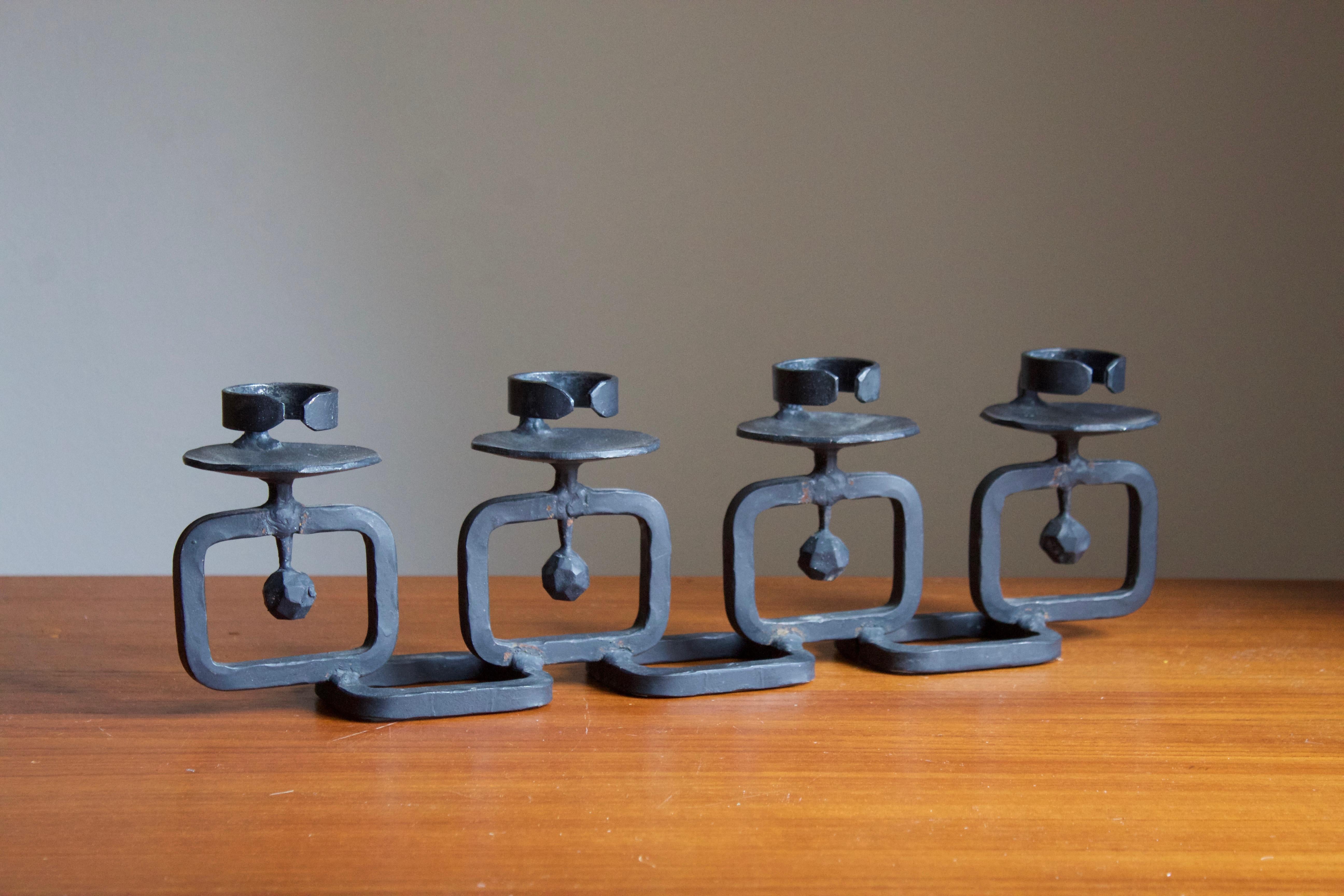 A sizable candelabra in cast iron. Designed and produced in Sweden, 1960s. Holds four block lights.

 