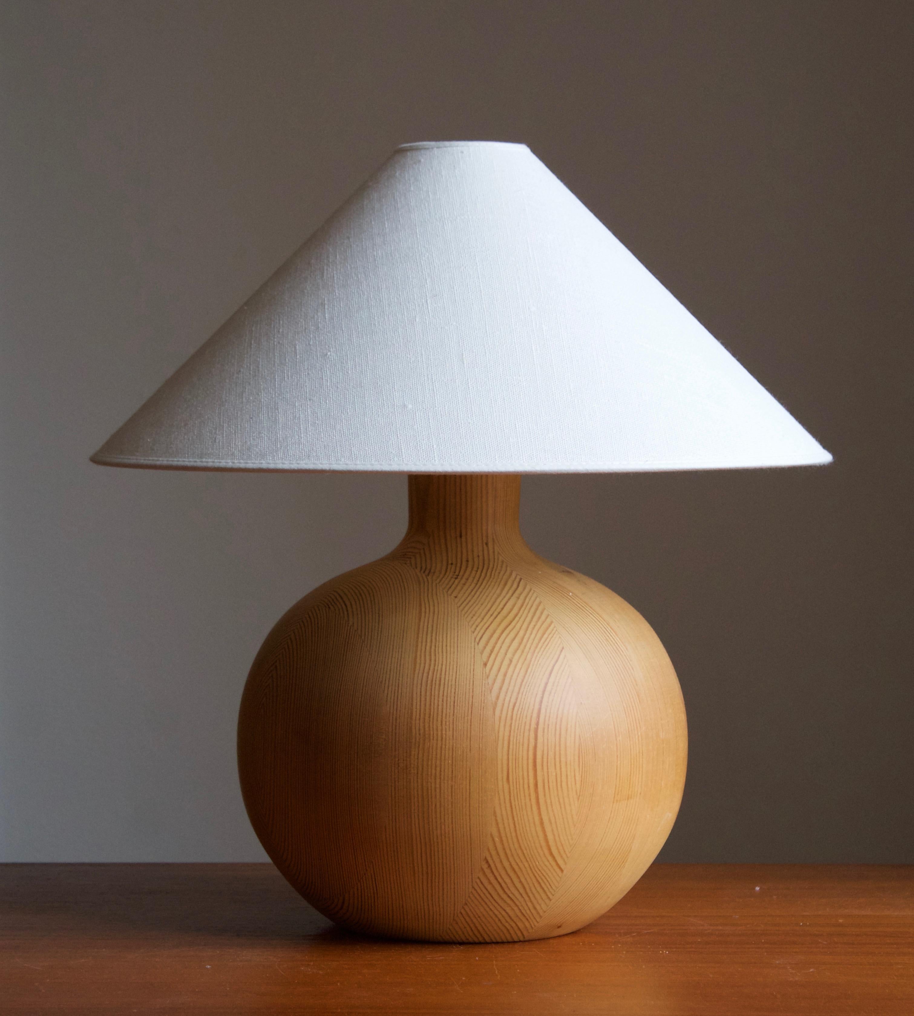 A sizable pine table lamp, designed and produced in Sweden, c. 1970s. 

Stated dimensions exclude lampshade. Height includes socket. Sold without lampshades.