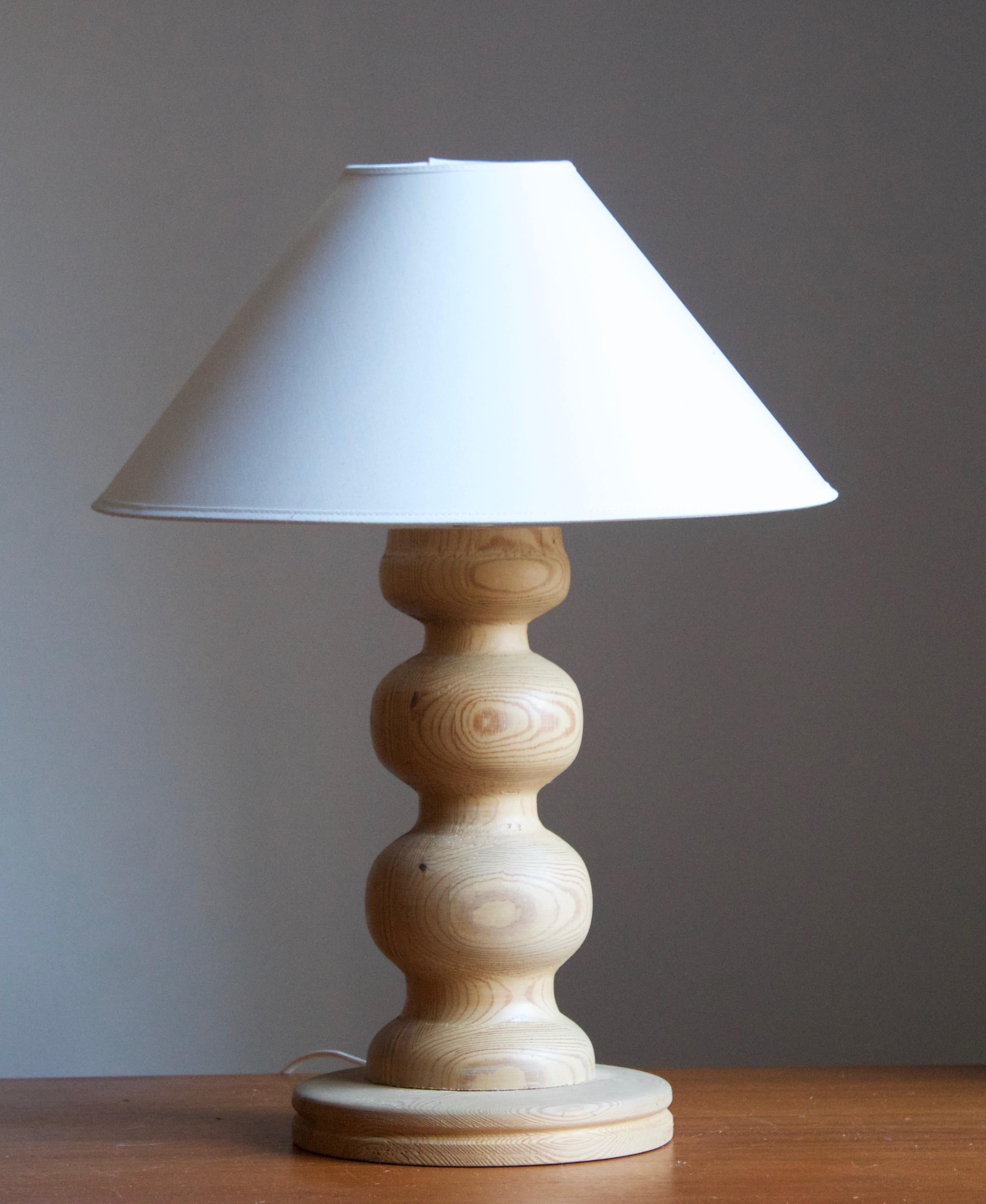 A sizable pine table lamp, designed and produced in Sweden, c. 1970s. 

Stated dimensions exclude lampshade. Height includes socket. Sold without lampshade.