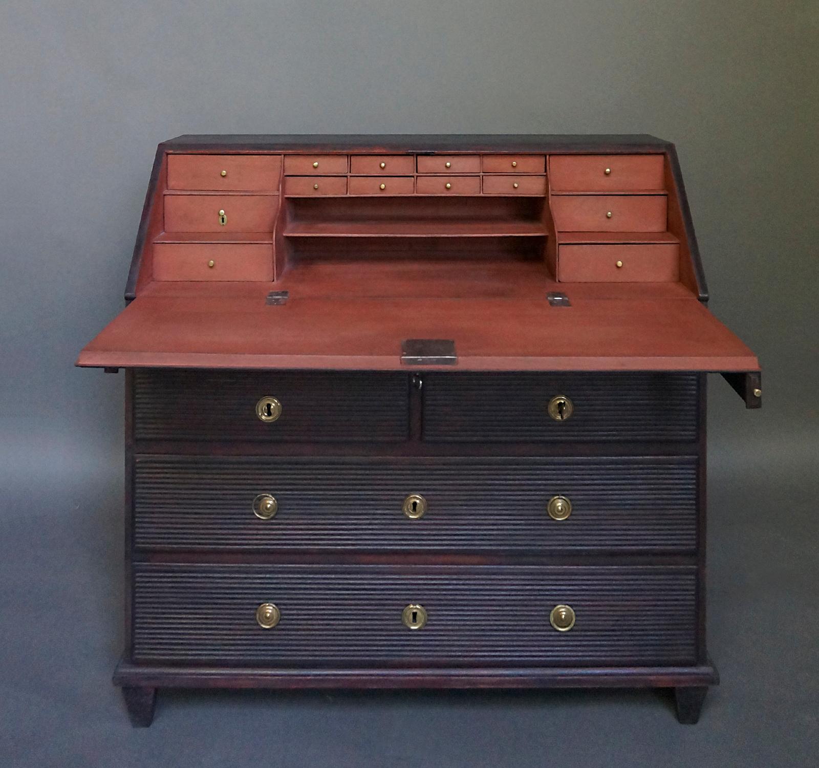 19th century Swedish writing desk, circa 1860. The fitted interior has multiple small drawers, one of them fitted with a tiny brass lock. Below the slant front is a shallow drawer over a pair of half-width drawers over two full -width drawers.