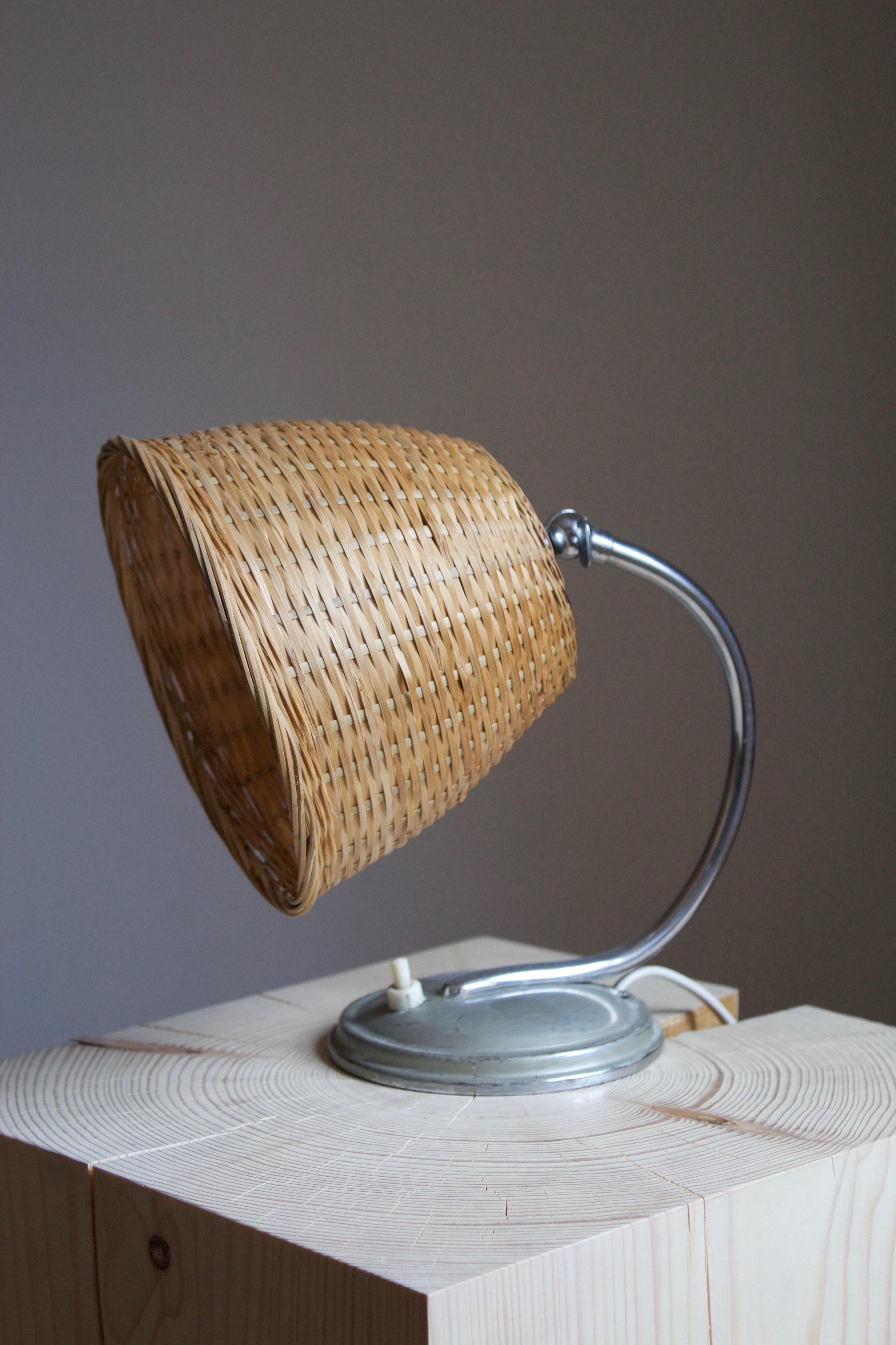 A small functionalist table lamp. Designed and produced in Sweden, c. 1940s. Assorted vintage rattan lampshade.

