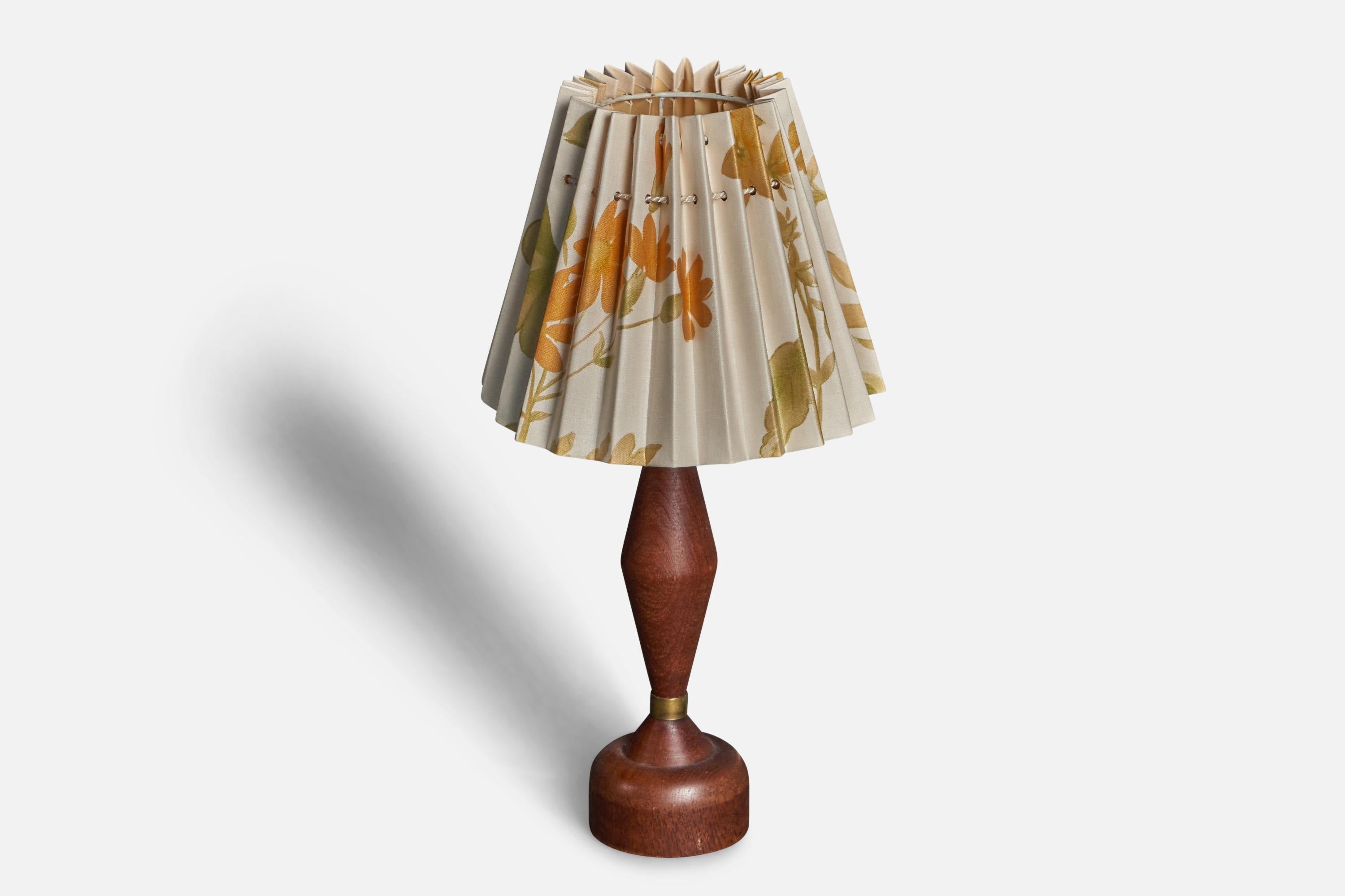 A small table lamp. In solid teak, with brass detailing.  Produced in Sweden, 1960s. Sold with linen lampshade.