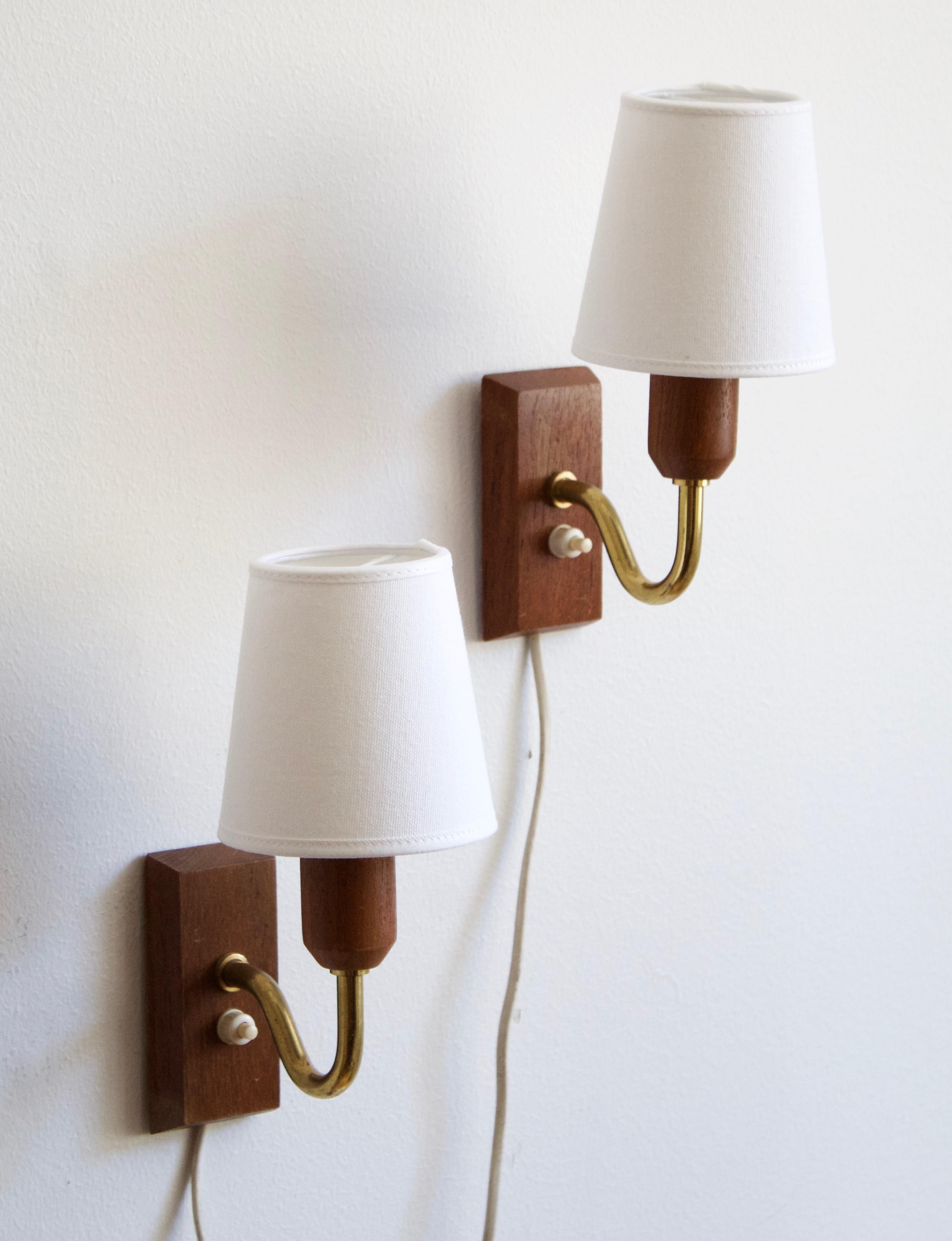 A pair of small wall lights / sconces. Designed and produced in Sweden, 1950s.
 