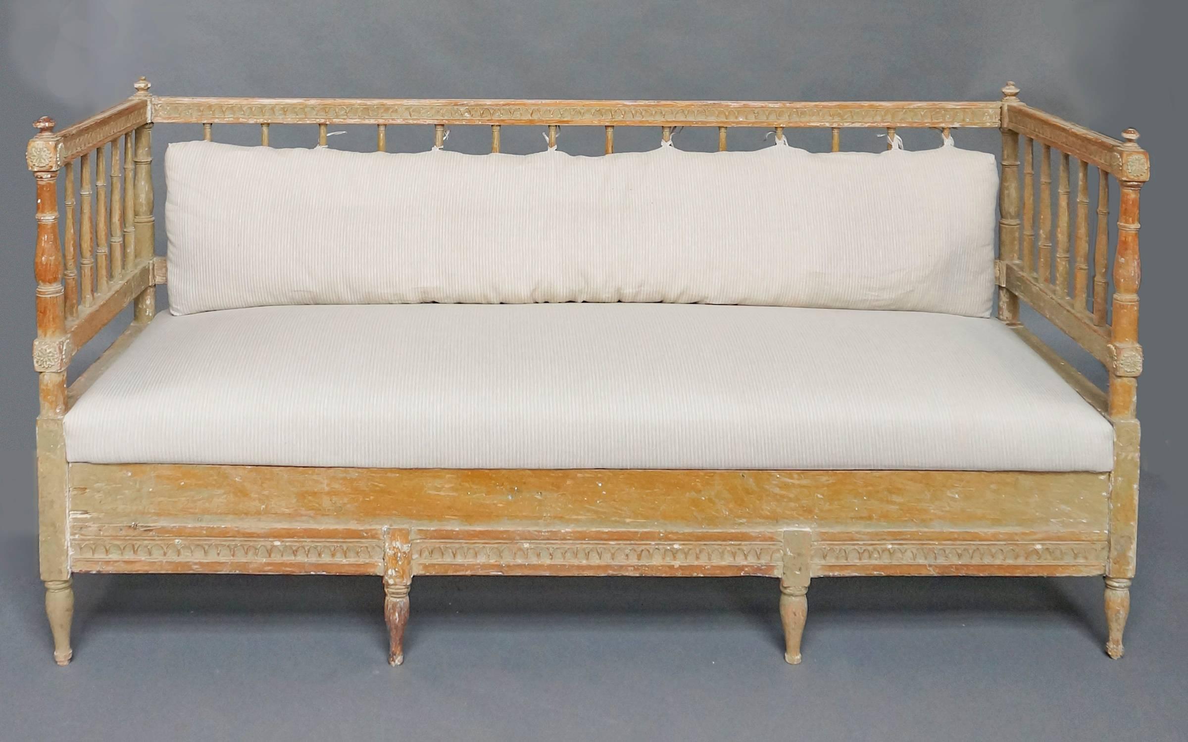Gustavian sofa, Sweden circa 1800, with upholstered seat and open back and arms. Beautifully turned posts and spindles with hand-carved lambs tongue molding on the horizontal elements. The seat removes to reveal a storage space initially used for