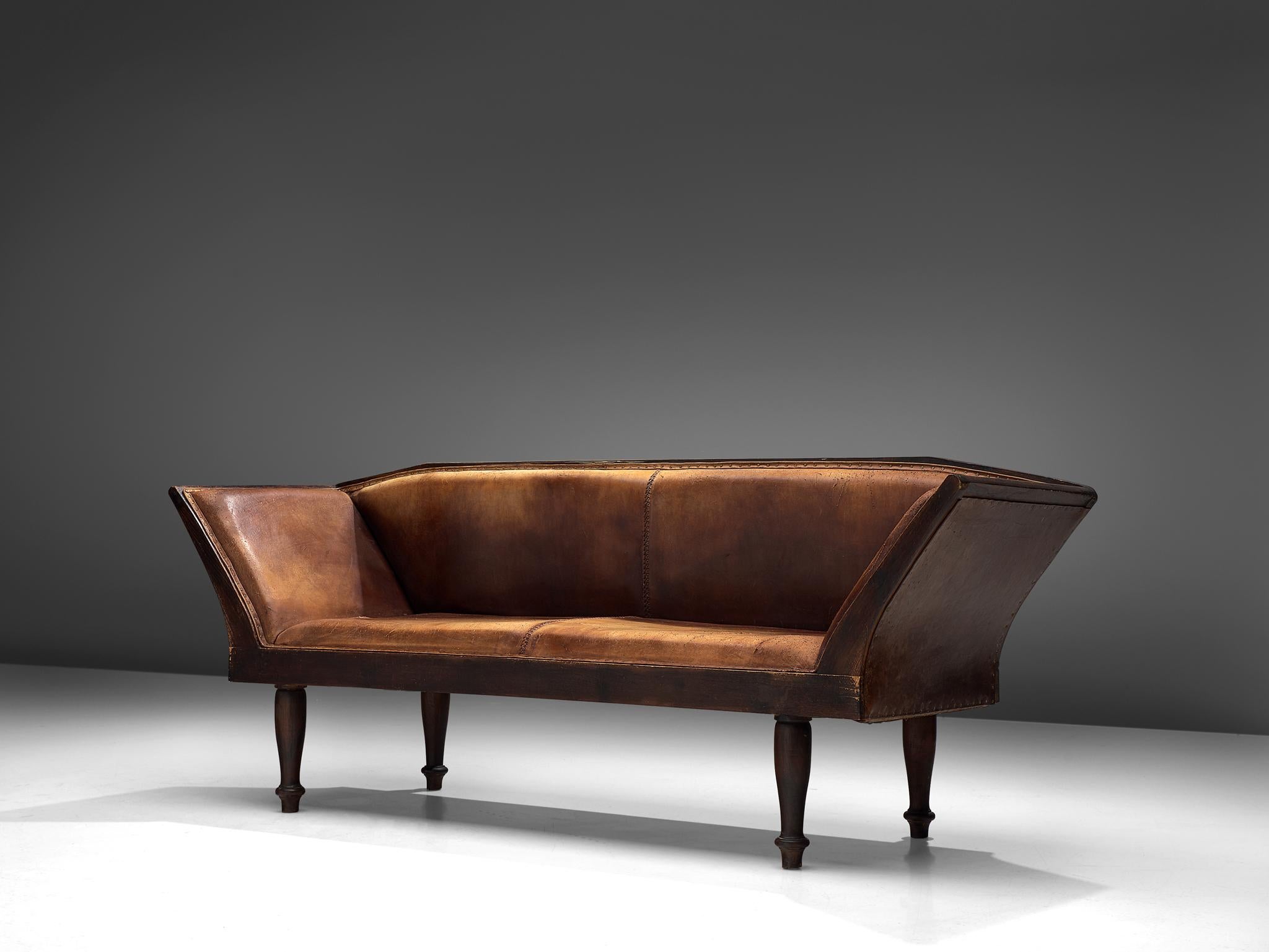 Sofa or settee, teak, leather, brass, Sweden, 1940s

This classic sofa of Swedish origin features a graceful composition crafted from the finest materials. The composition of the corpus is predominately defined by trapezoid forms with strict lines