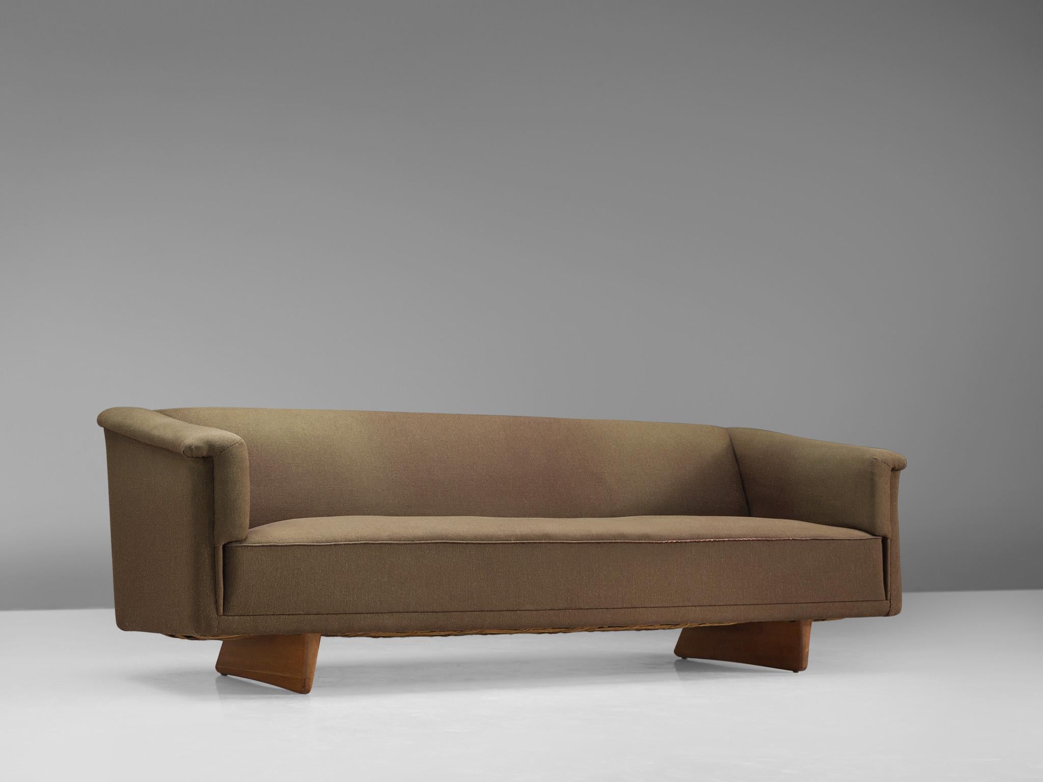 Sofa, fabric and wood, Sweden, 1960s. 

Three-seat sofa in green to brown fabric. The two wooden sledges provide a floating appearance to this comfortable sofa. The armrests are modestly curved and give this sofa an elegant expression by means of