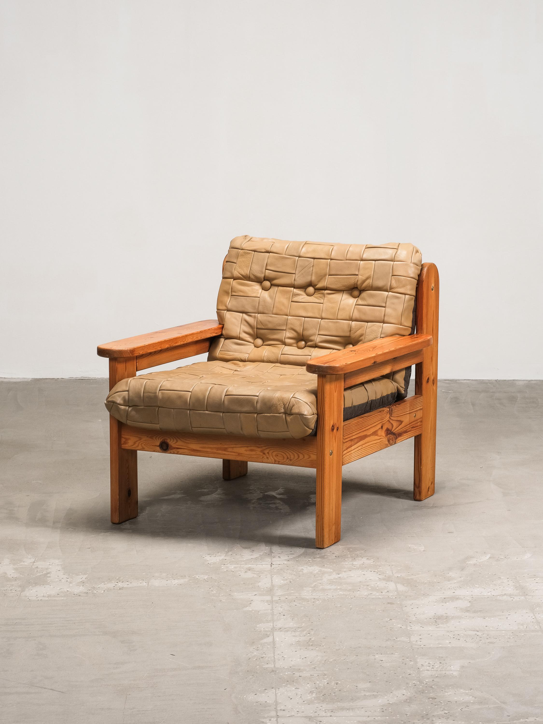 A bold and rustic statement from 1970s Sweden, this lounge chair captures the essence of Scandinavian craft through its robust construction and distinctive materials. The frame, carved from solid pine, features clean lines and gently angled