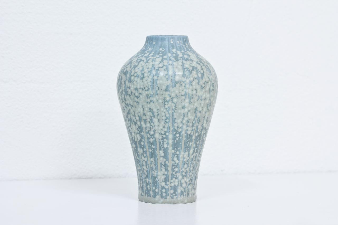 Stoneware vase designed by Gunnar Nylund, hand thrown at Rörstrand in Sweden during the 1940s. Light blue, speckled grey glaze on an incised stripe pattern. Hand signed.