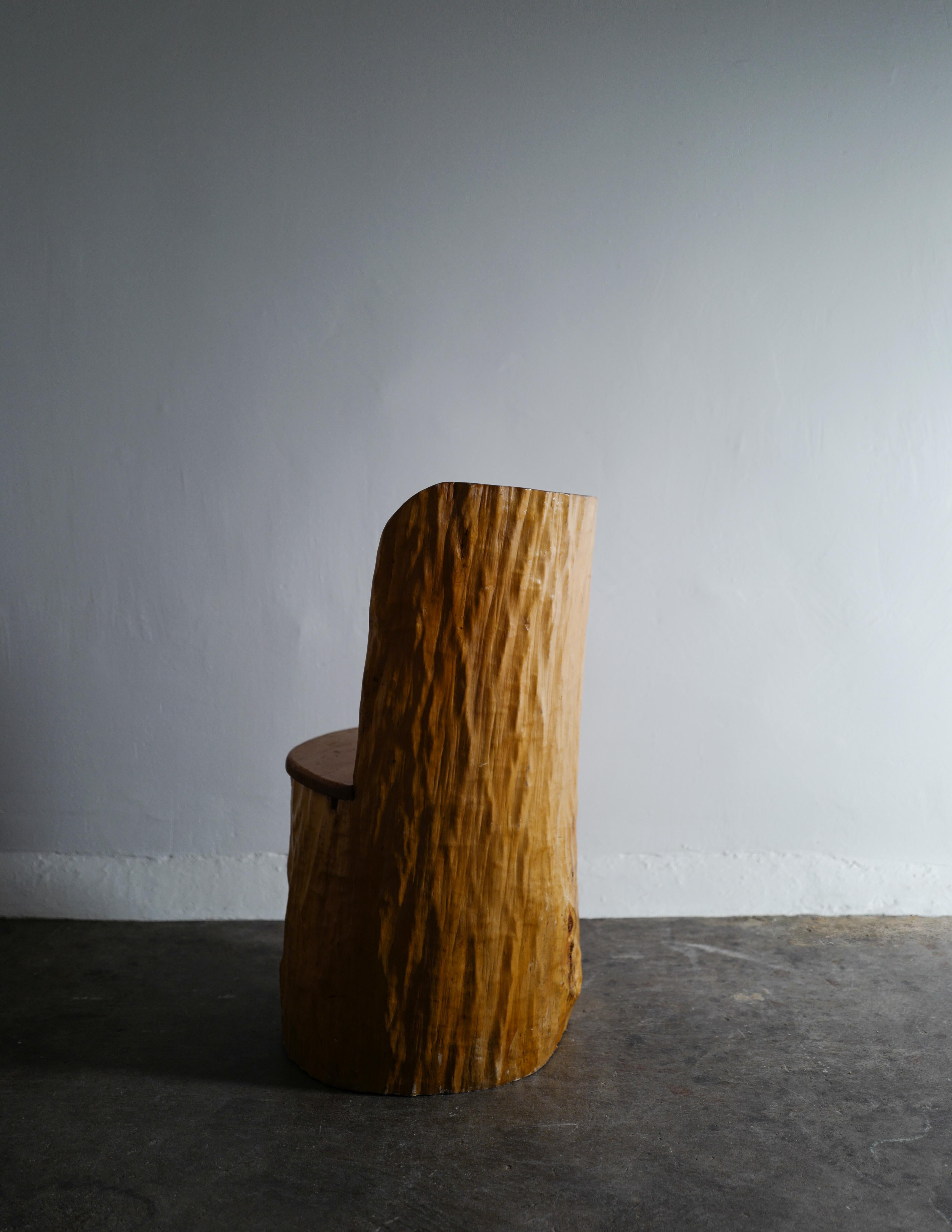 Rare and good example of a Swedish stump chair in pine by an unknown maker from Dalarna, Sweden. 
In good original and vintage condition. Signed H.H and 1968.