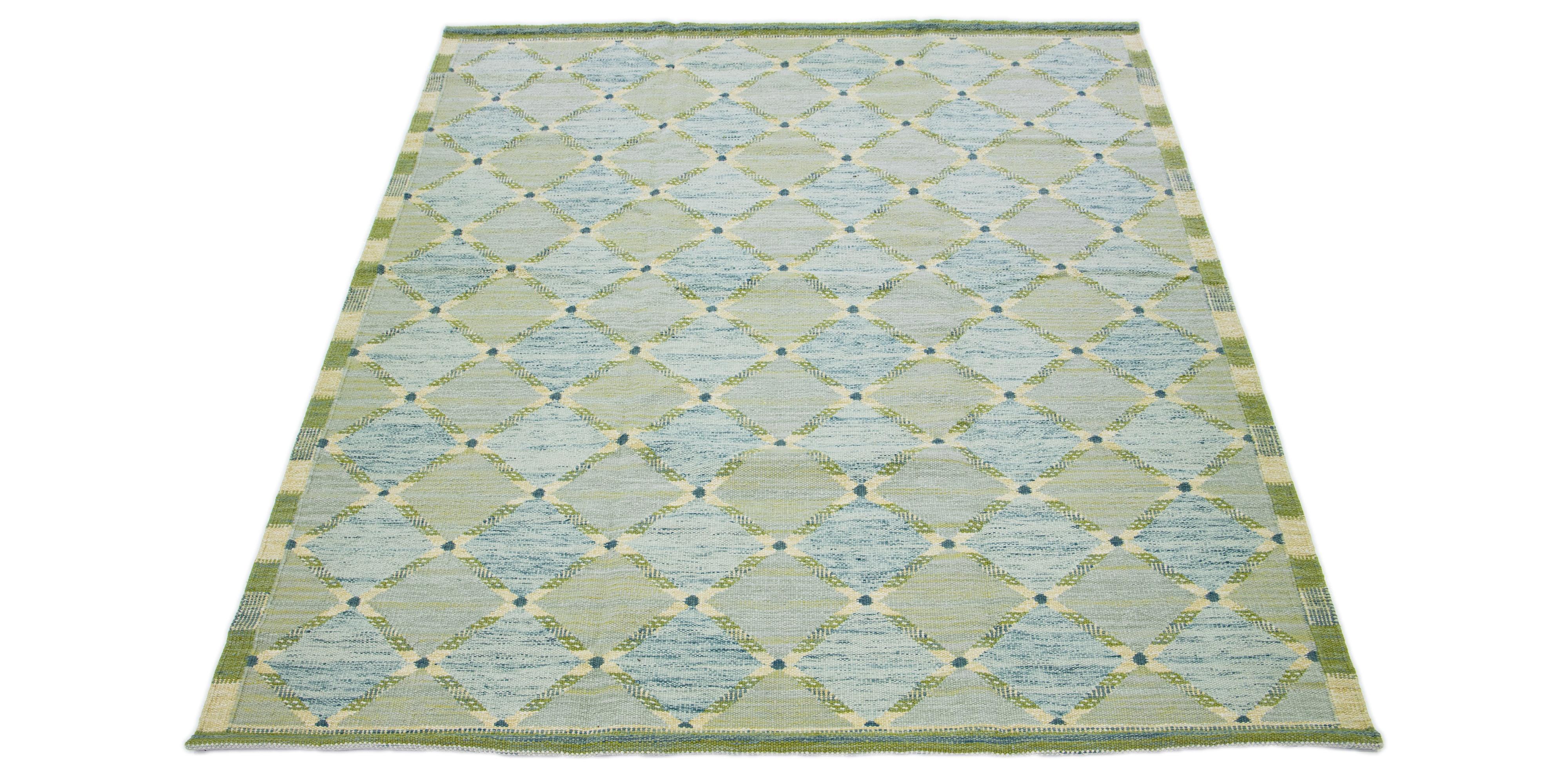 This flatweave rug exhibits a modern Swedish design featuring a delicate green base. Enhanced by a striking geometric pattern throughout, it includes subtle additional colors that provide an elegant aesthetic to any environment.

 This rug measures