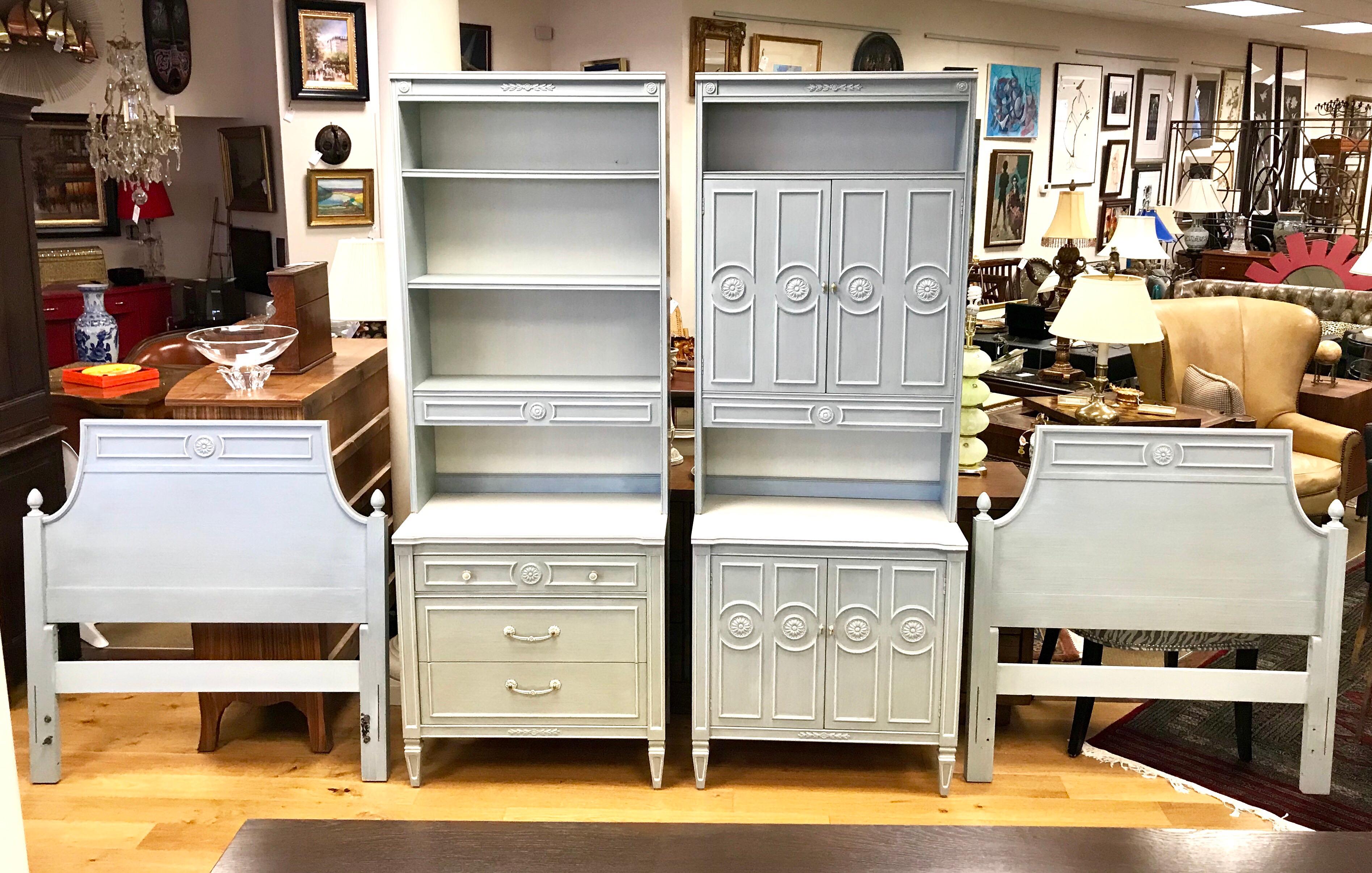 Swedish style painted bedroom set in a pretty light blue grey finish with applied medallions and molding. The set includes two chest of drawers that have removable bookcases, one is open the other has doors. The twin headboards are twin size and can
