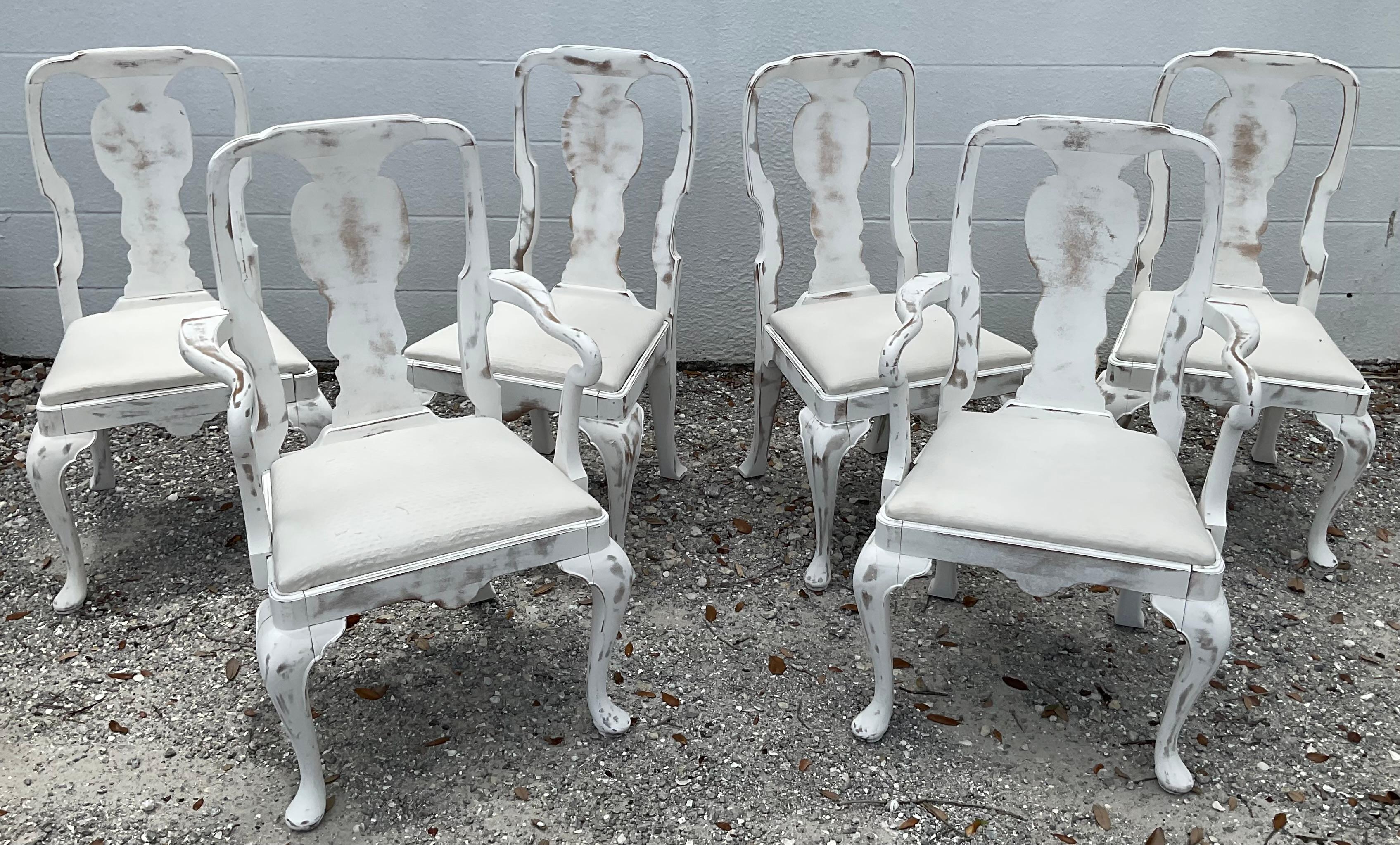 Set of six (6) elegant Swedish style Queen Anne Dining Chairs. Classic Queen Anne back rest, with rounded shoulders and cabriole legs. Set consists of two armchairs and four side chairs all painted in a wonderful white distressed finish with