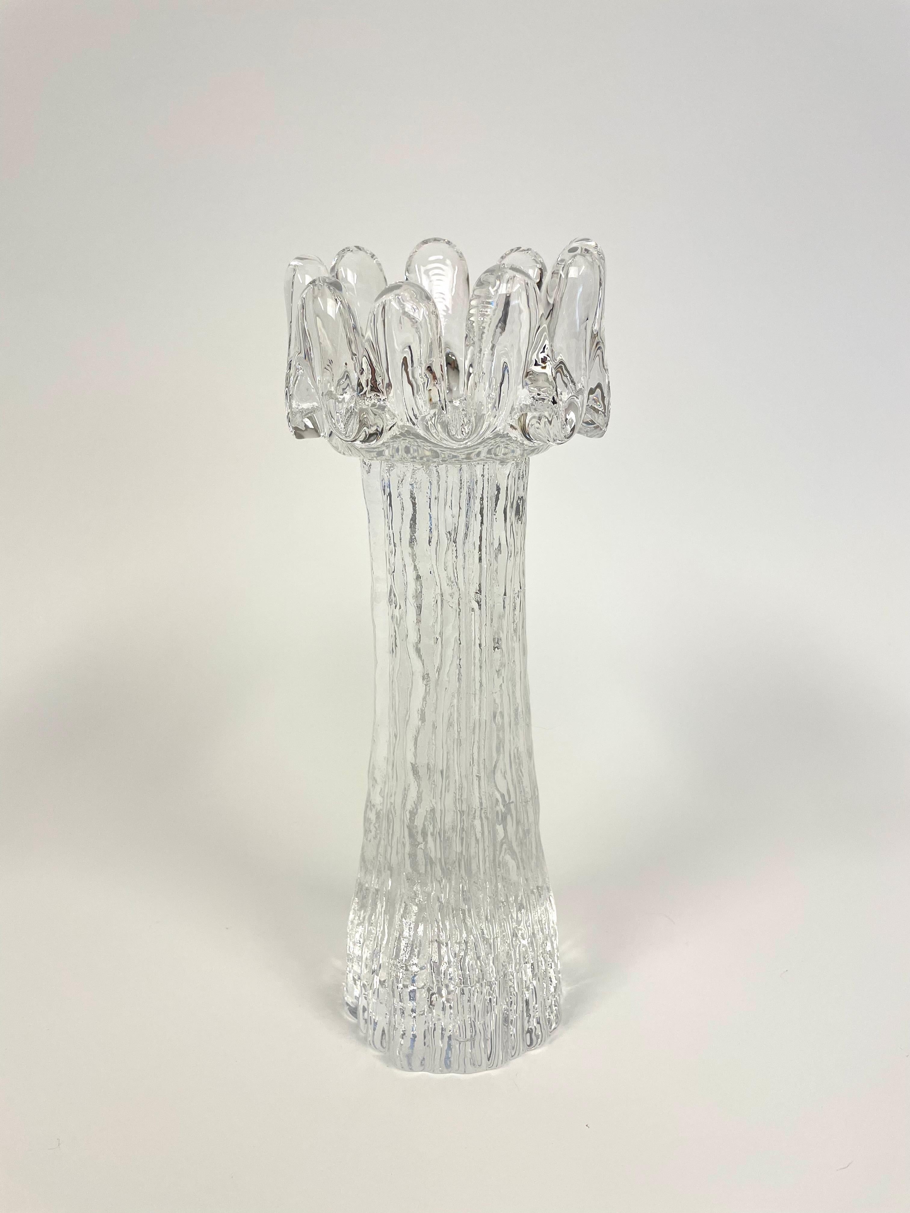 This is a Swedish set of 6 pieces Sunflower candlesticks set by the glass artist Göran Wärff for Kosta Boda Glasbruk. 

It comes with 6 crystal candlesticks in different sizes and shapes that brings to mind the stout stem of a sunflower, crowned by