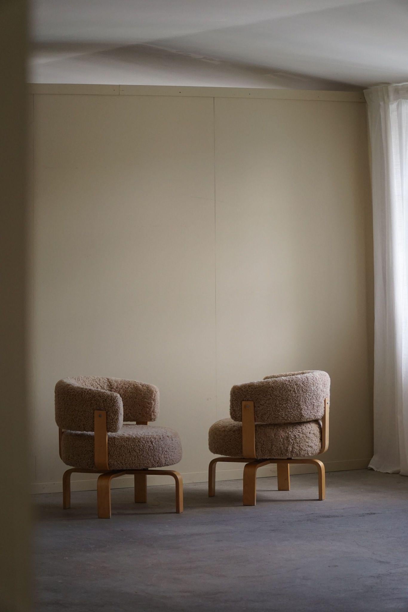 A lovely cosy 360 degree swivel armchair, reupholstered in a great quality shearling lambswool, frame and legs made of bented beechwood. Designed by Carina Bengs for Ikea in 2004. Model “Fidene”, out of production today. 

Sold individually and as a
