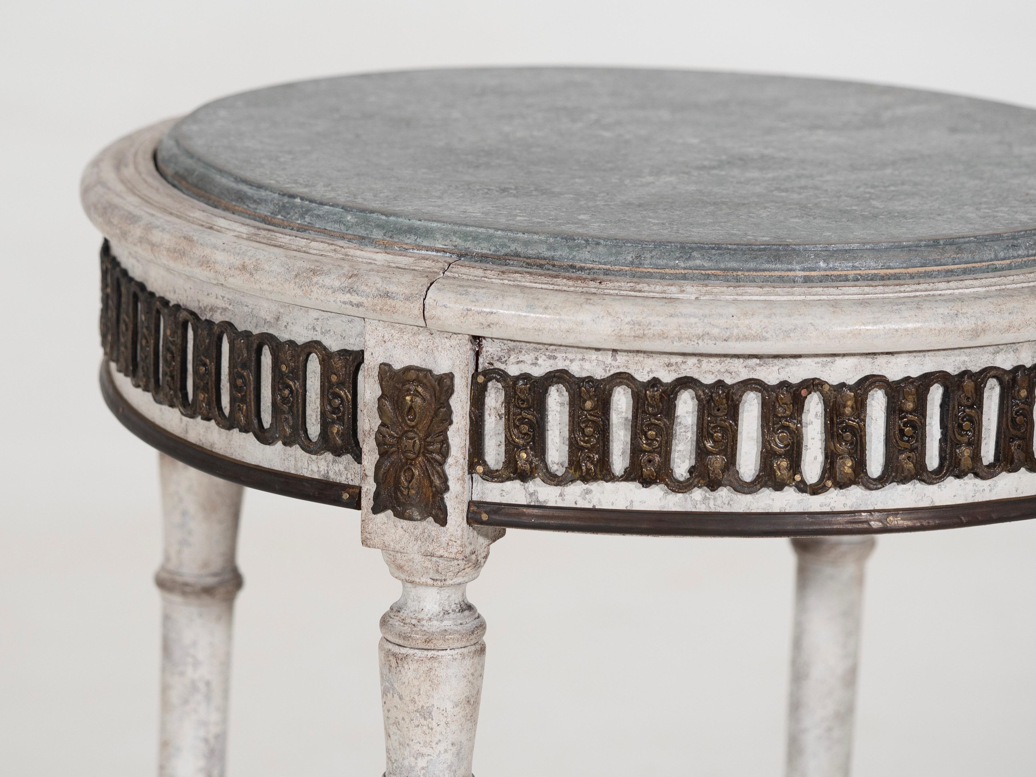 Charming freestanding Swedish table with original hardware and faux painted marble top, richly carved, 19th Century.