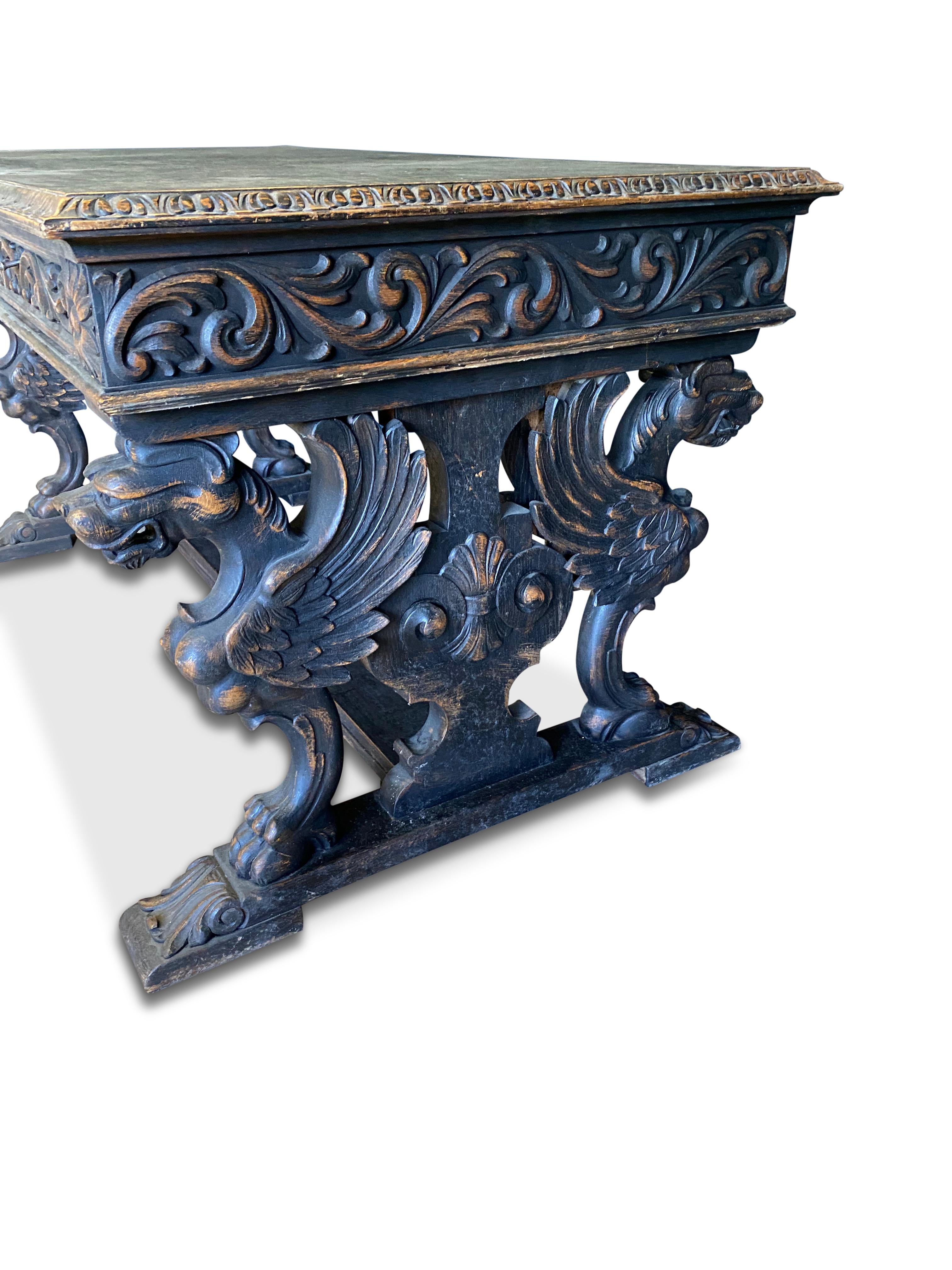 Stunning Swedish 20th Century carved oak Desk or Table.This piece features a rectangular top with a moulded and intricately carved edge. The top rests on a substantial frieze, carved in the round with elegant foliate decoration and rosettes to each