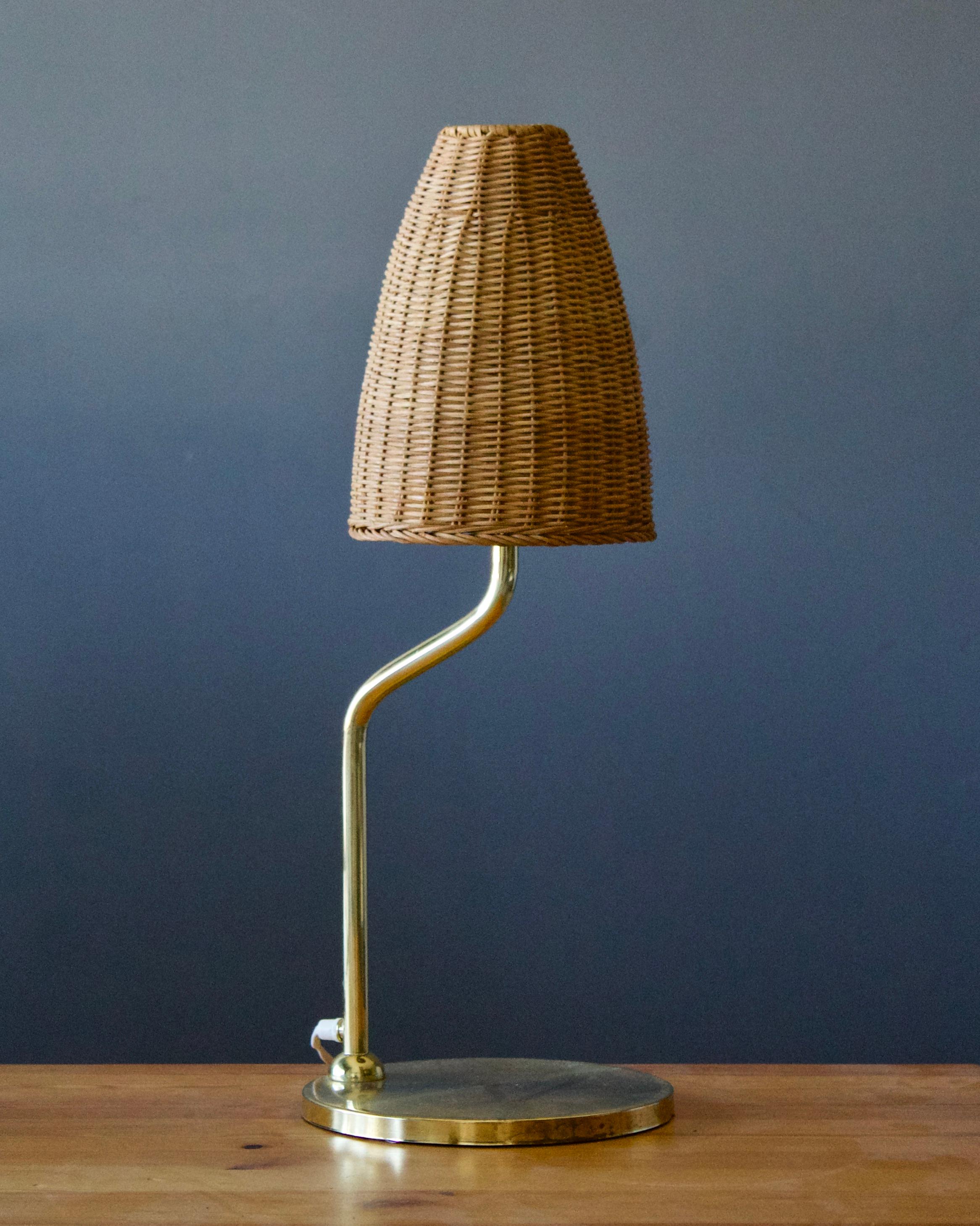 A table lamp, designed and produced in Sweden, 1950s. In brass. With assorted rattan lampshade.


 