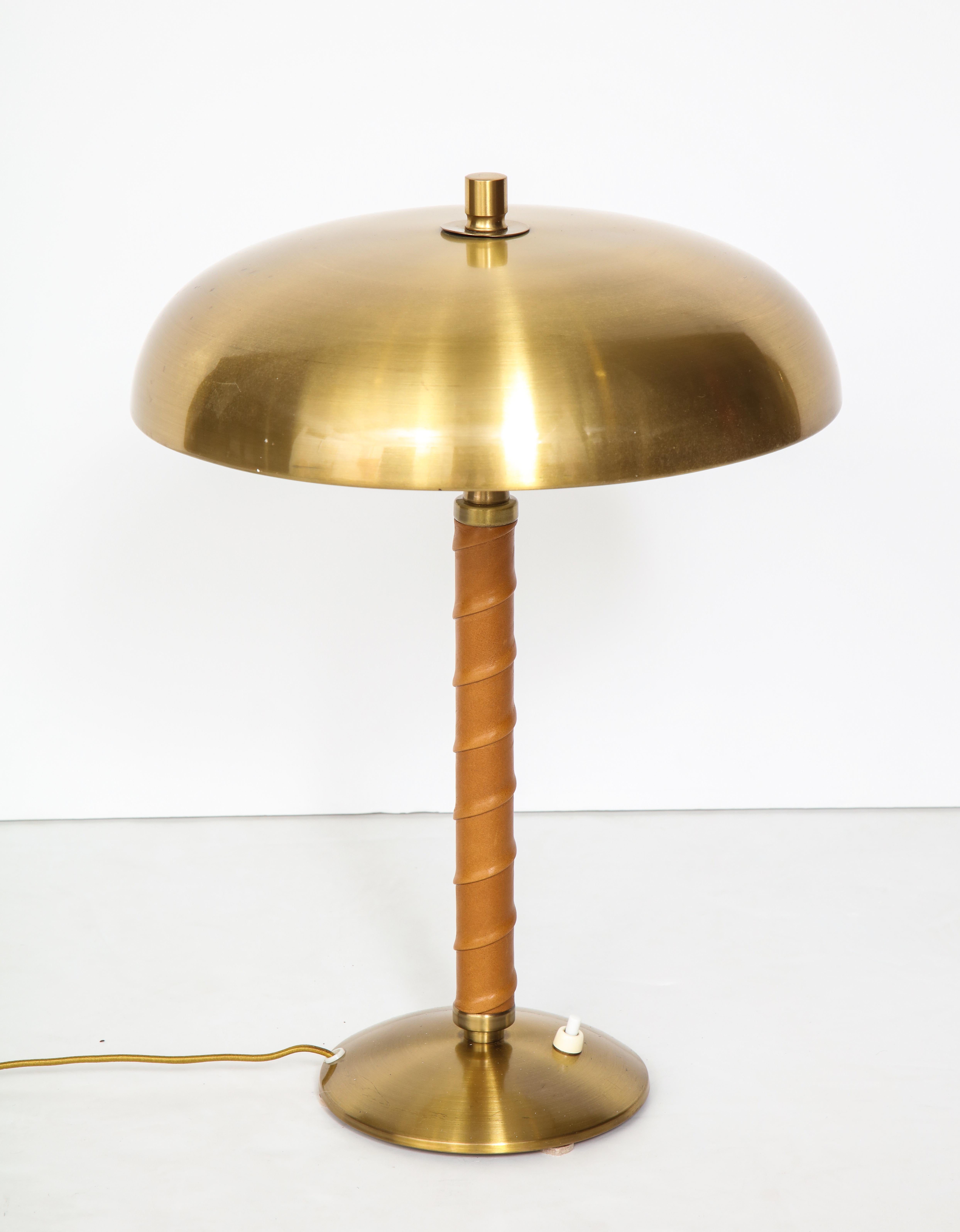 Swedish table lamp by Einar Båckström, Malmö, circa 1940s dome brass top with a leather wrapped stem. Restored and rewired for US (2 x 60w max). Stamped on the base.