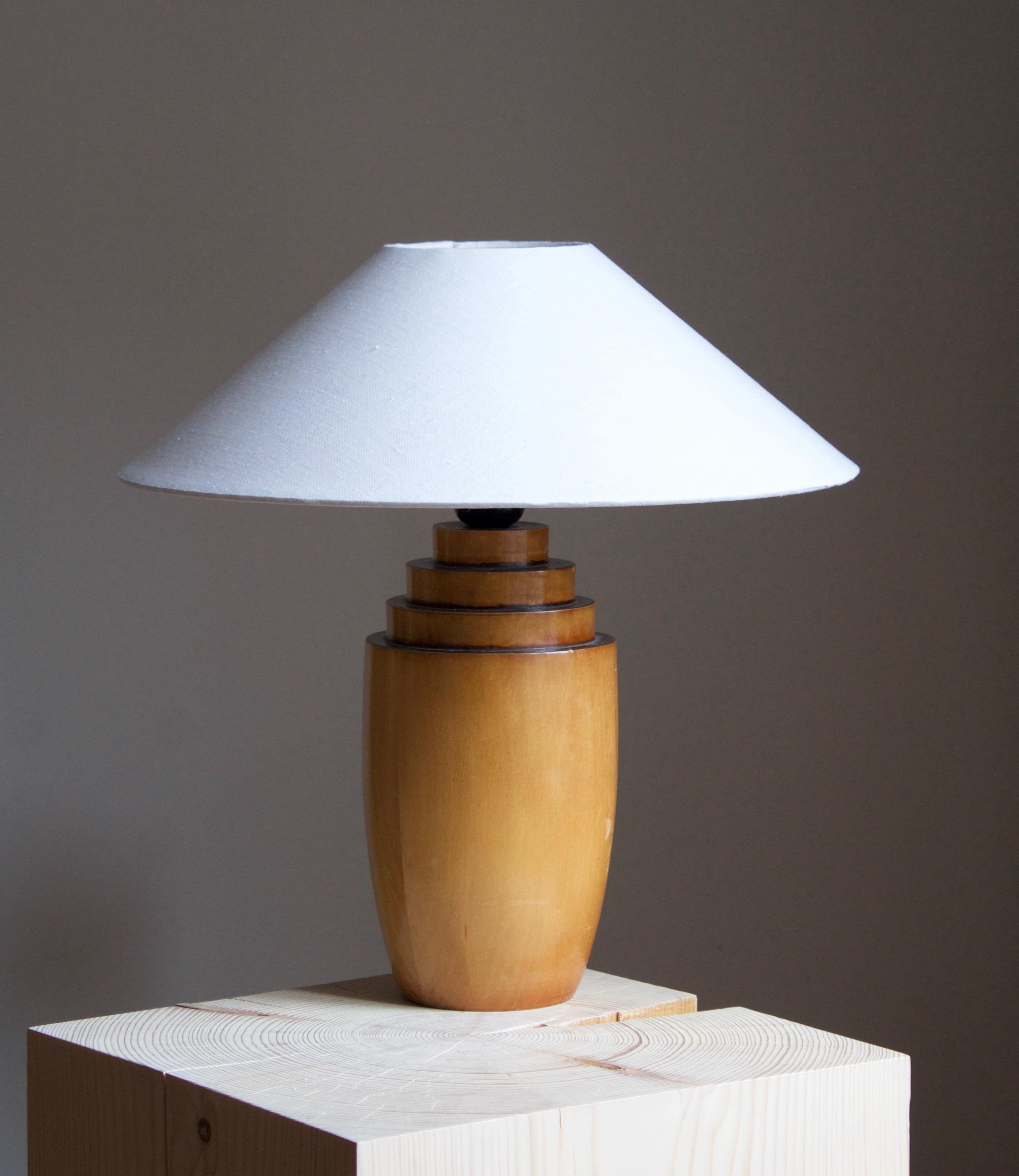A table lamp designed and produced in Sweden, 1970s. In birch. 

Stated dimensions exclude lampshade. Height includes socket. Sold without lampshade.
    