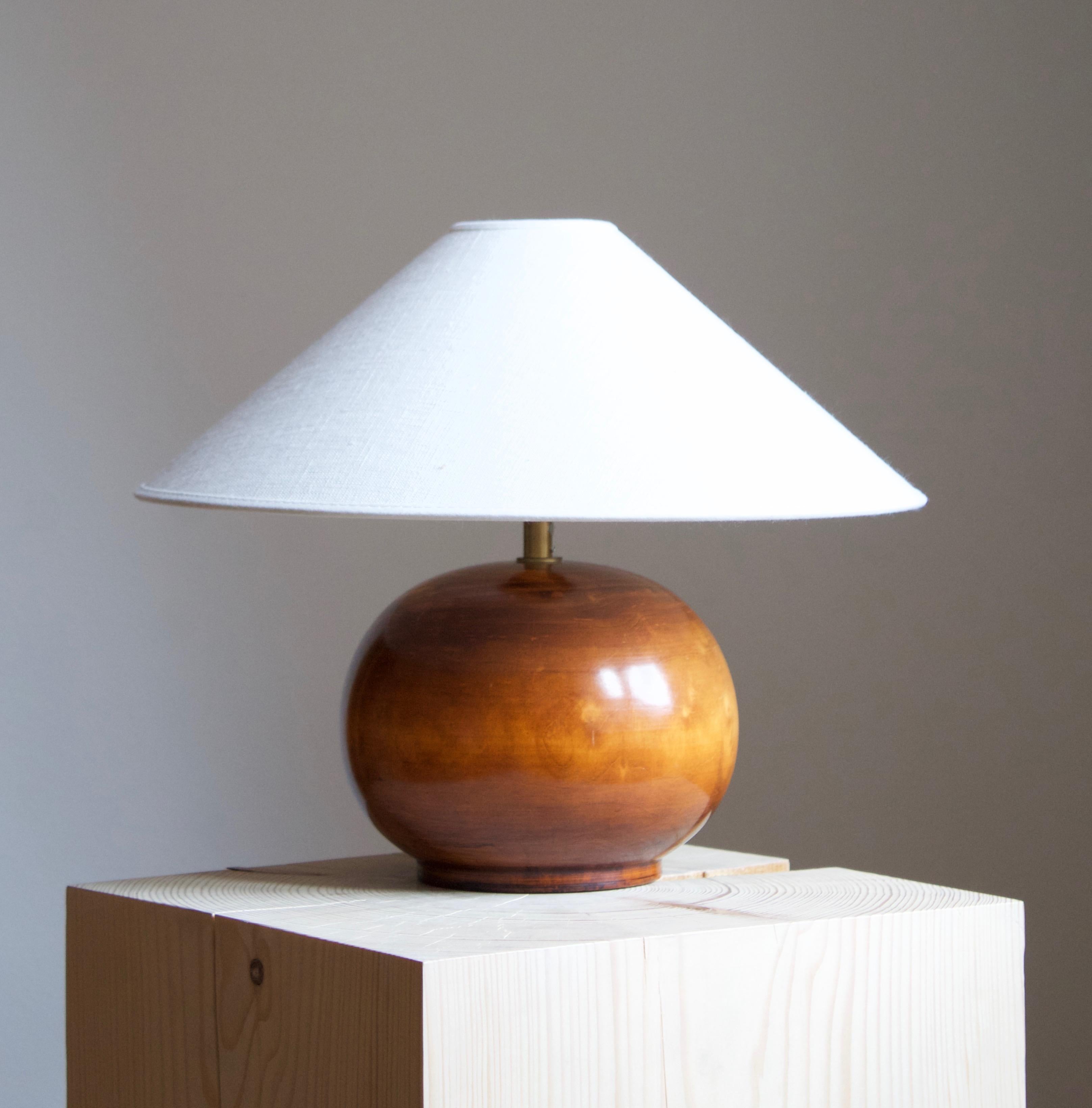 A table lamp, in lacquered pine, socket raised on brass tube. Produced in Sweden c. 1970s.

 