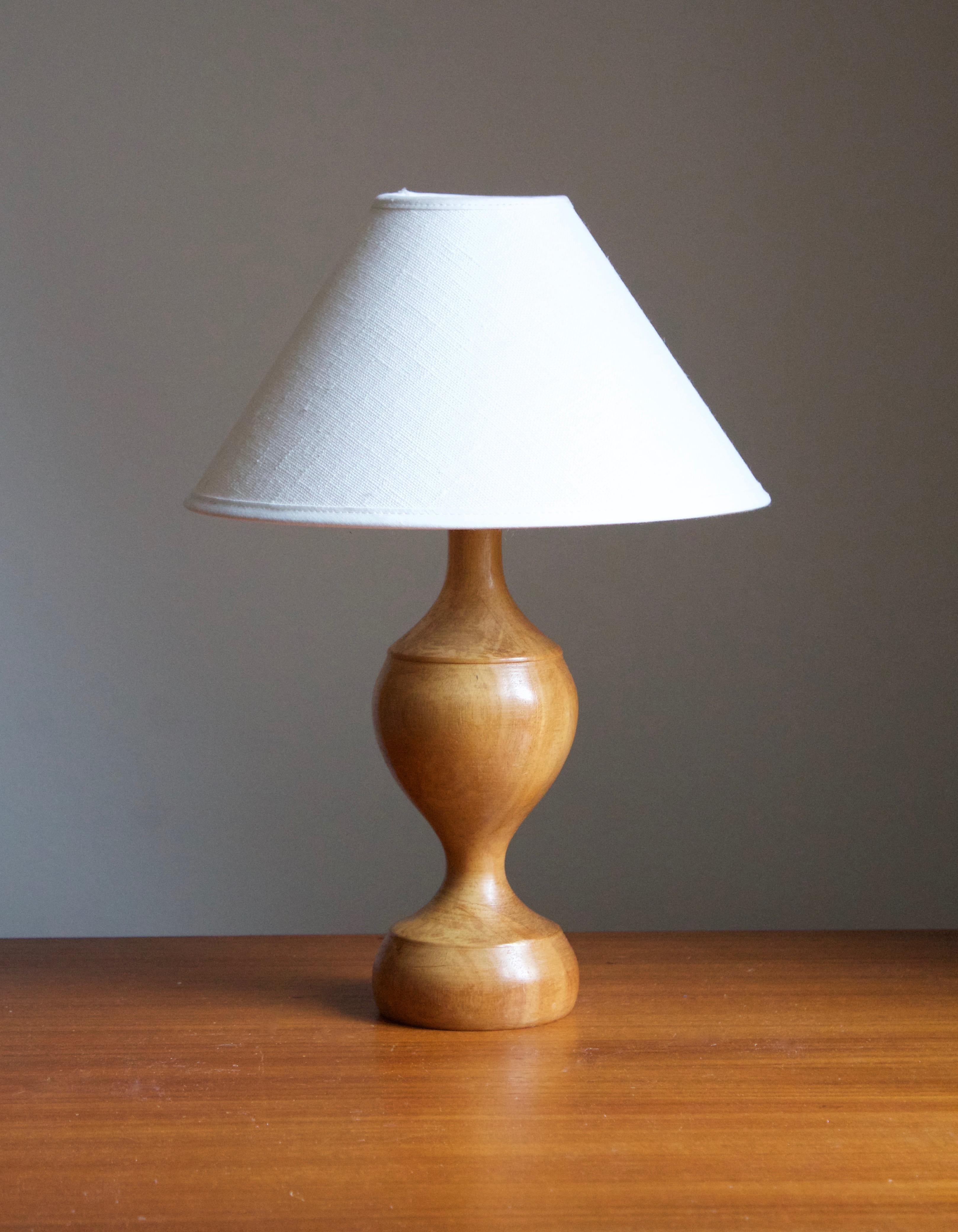 A table lamp designed and produced in Sweden, 1970s. In solid birch. 

Stated dimensions exclude lampshade. Height includes socket. Sold without lampshade.
