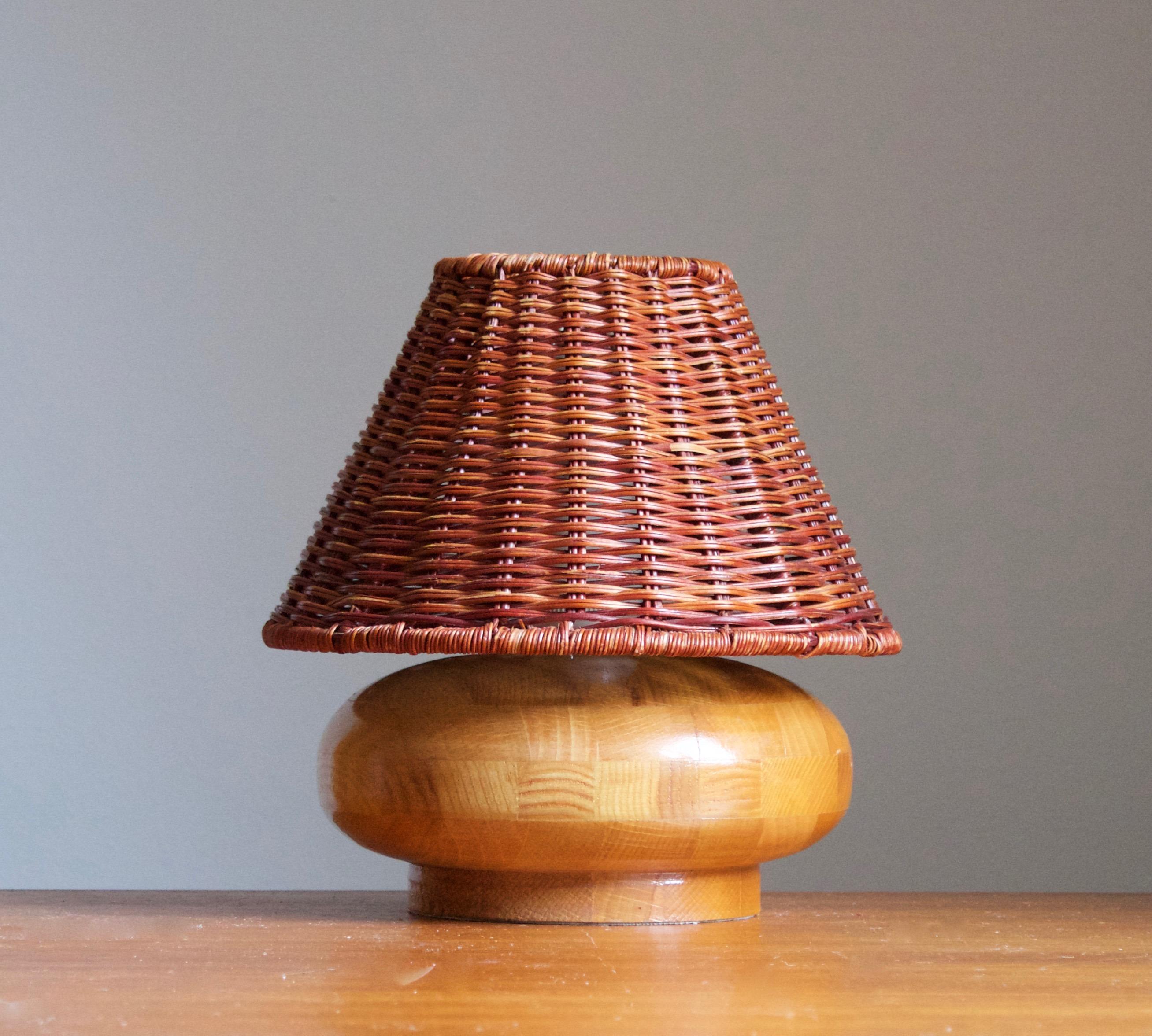 A table lamp designed and produced in Sweden, 1970s. 

Stated dimensions exclude lampshades, height includes socket. Upon request illustrated model rattan lampshades can be included in purchase.
