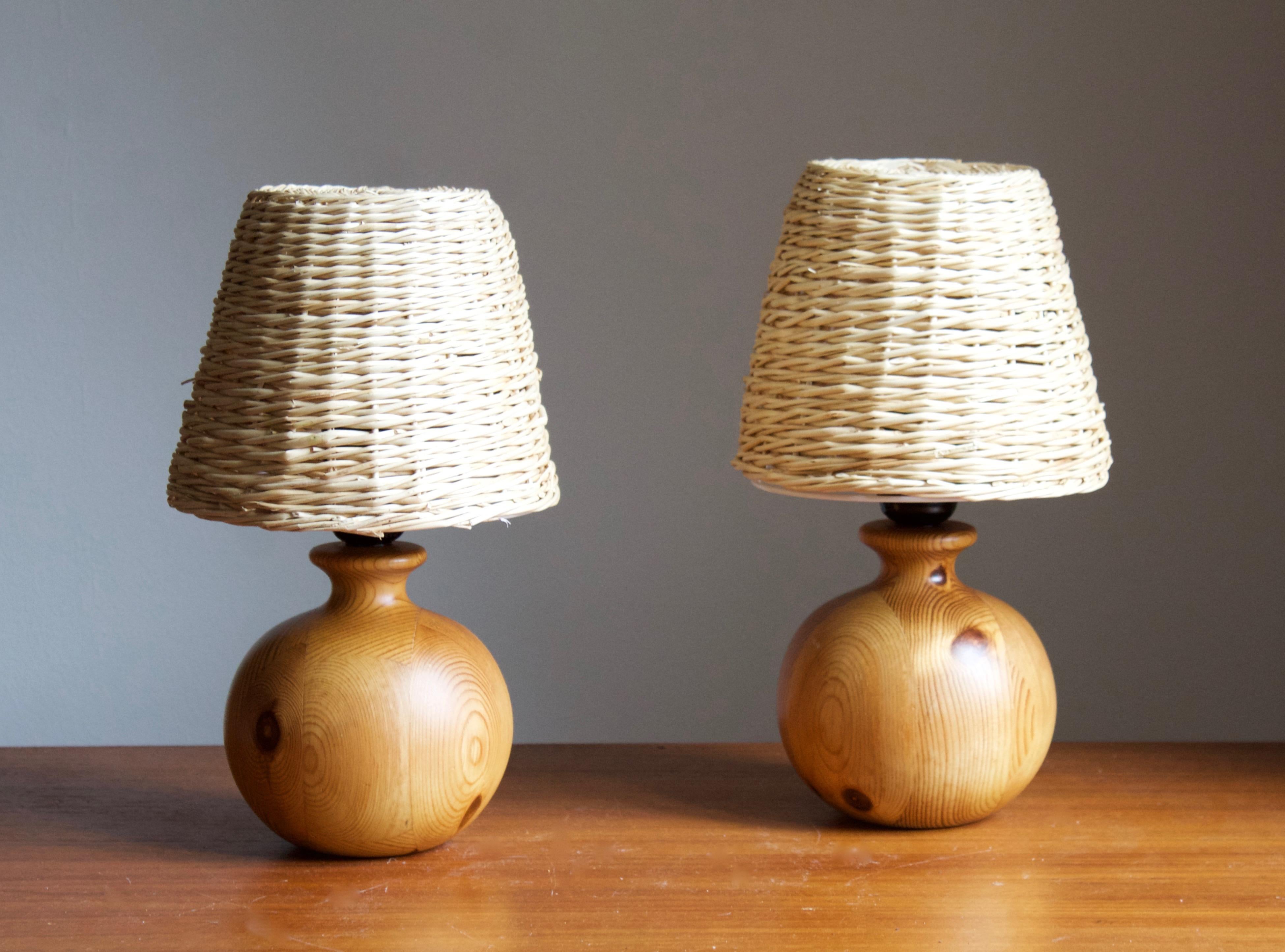 A pair of table lamps designed and produced in Sweden, 1970s. 

Stated dimensions exclude lampshades, height includes socket. Upon request illustrated model rattan lampshades can be included in purchase.