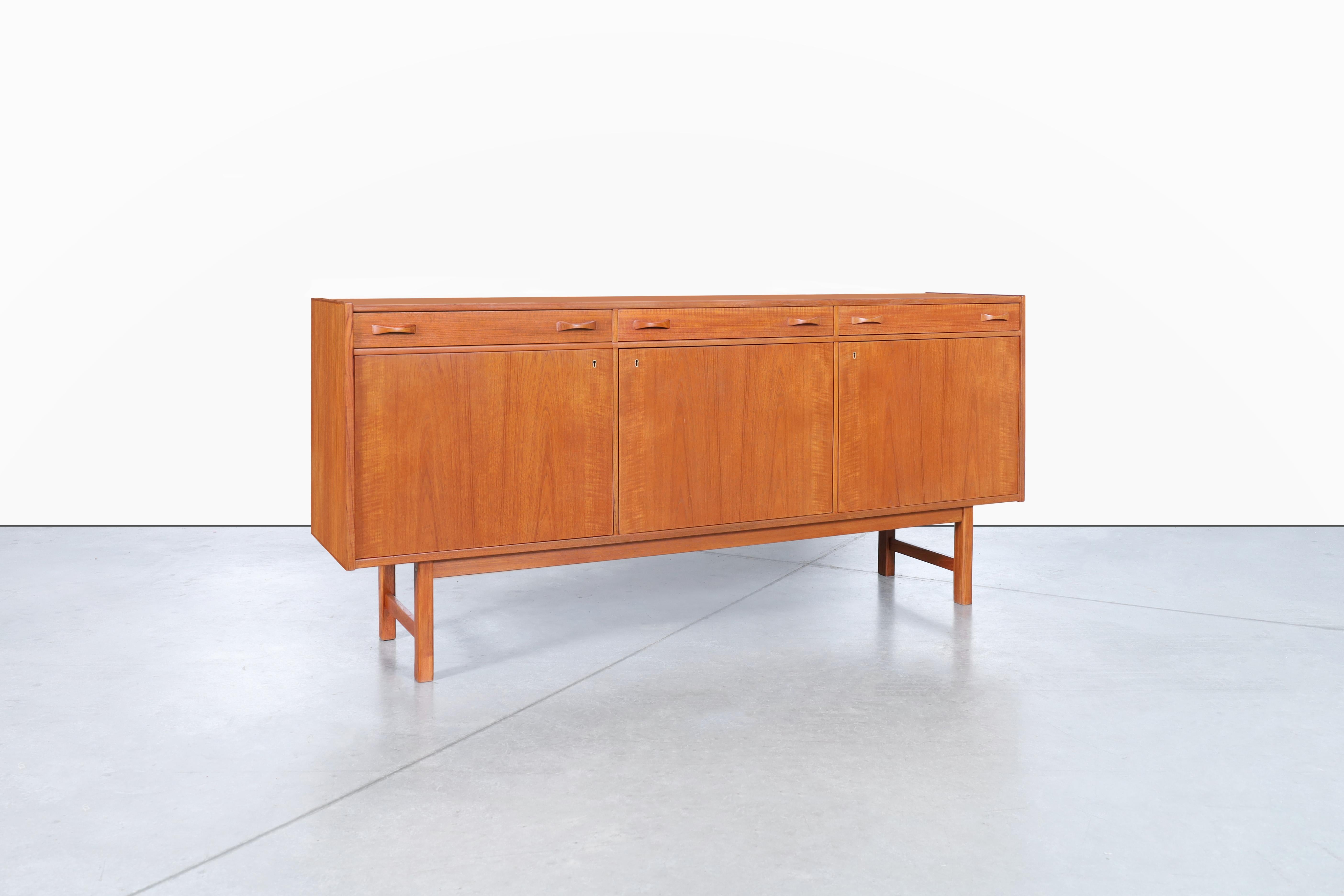 This mid-century teak credenza, designed by Tage Olofsson for Ulferts Mobler in Sweden during the 1960s, is a stunning piece of furniture crafted from the finest quality teak wood. Its elegant and characteristic Scandinavian design consists of three