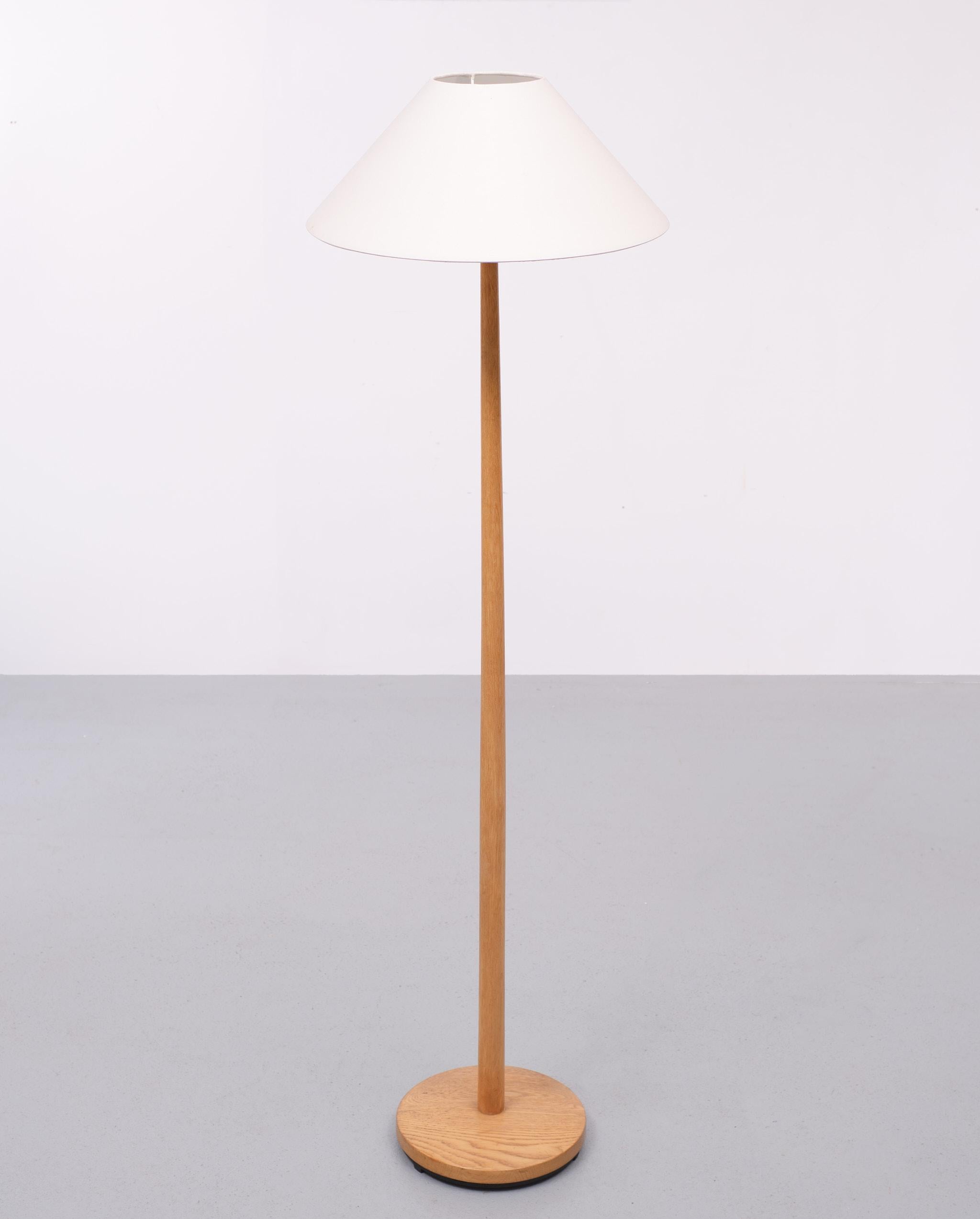 Minimalist Swedish modern floor lamp, circa 1960s. Made in Sweden for George Kovacs. 
with a tapered column, with rich wood and white shade. Good condition. Signed Kovacs