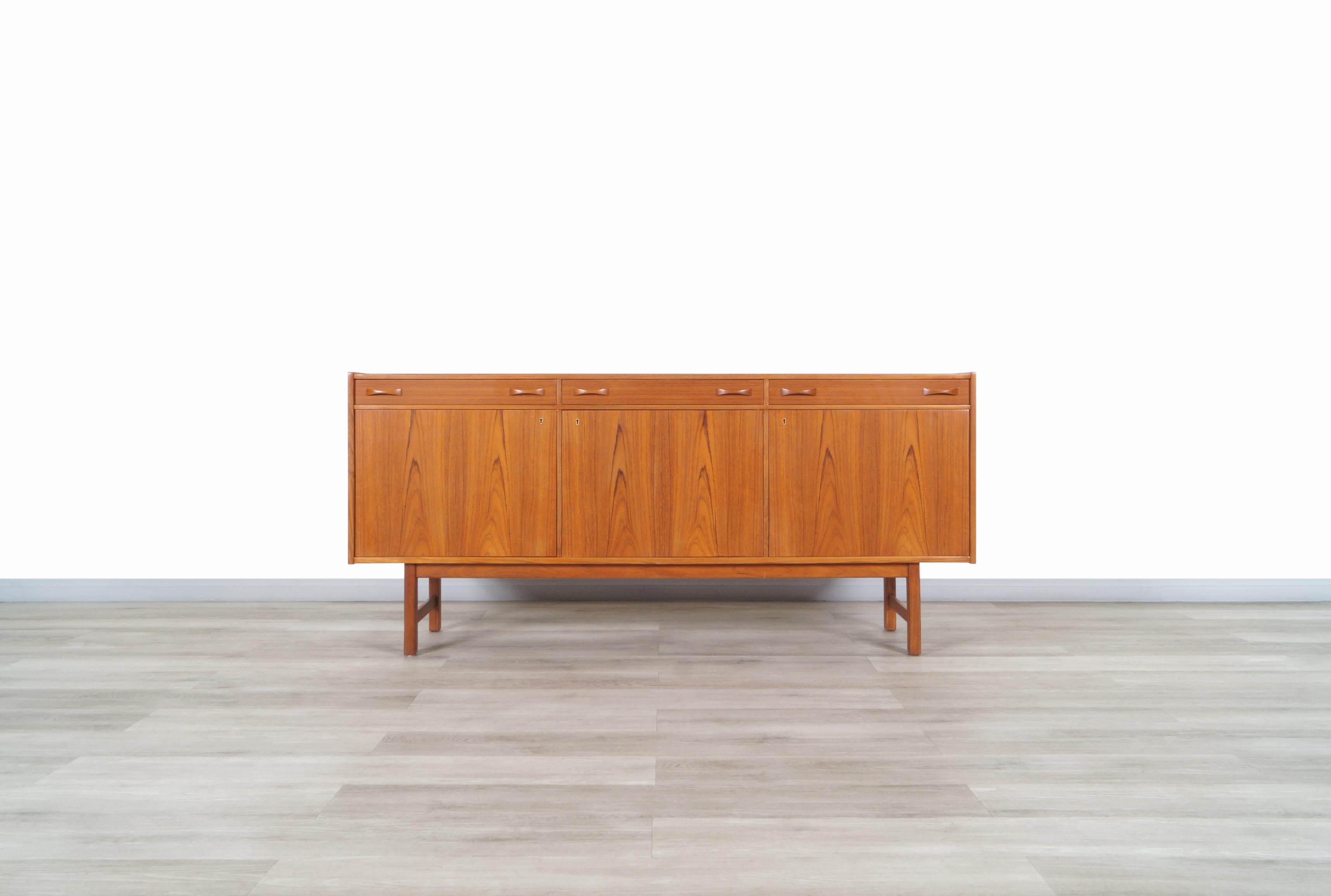 Fabulous midcentury teak sideboard designed by Tage Olofsson for Ulferts Møbler in Sweden, circa 1960s. This sideboard is made from the highest quality teak wood. It has an elegant and characteristic Scandinavian design. The upper part features 3