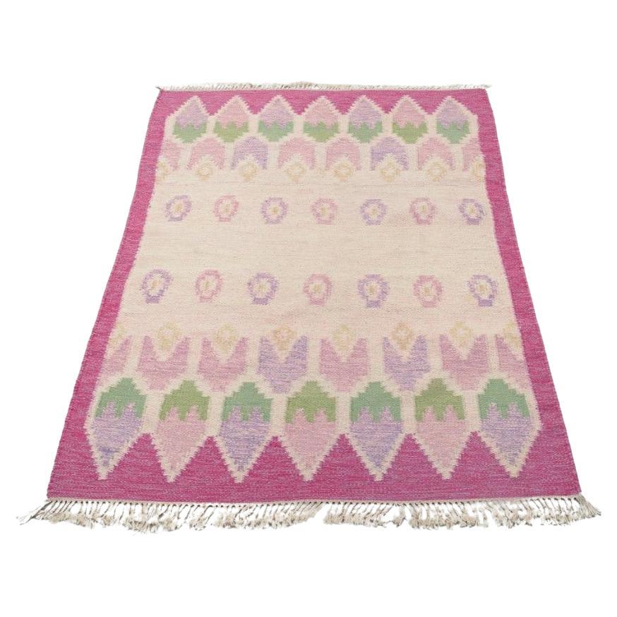 Swedish textile designer. Handwoven carpet in pure wool. Pink and blue colors.
