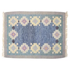 Swedish textile designer. Handwoven rug made of wool. Rölakan technique.