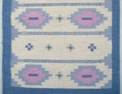 Swedish textile designer. Handwoven wool runner in blue, pink, and white colours