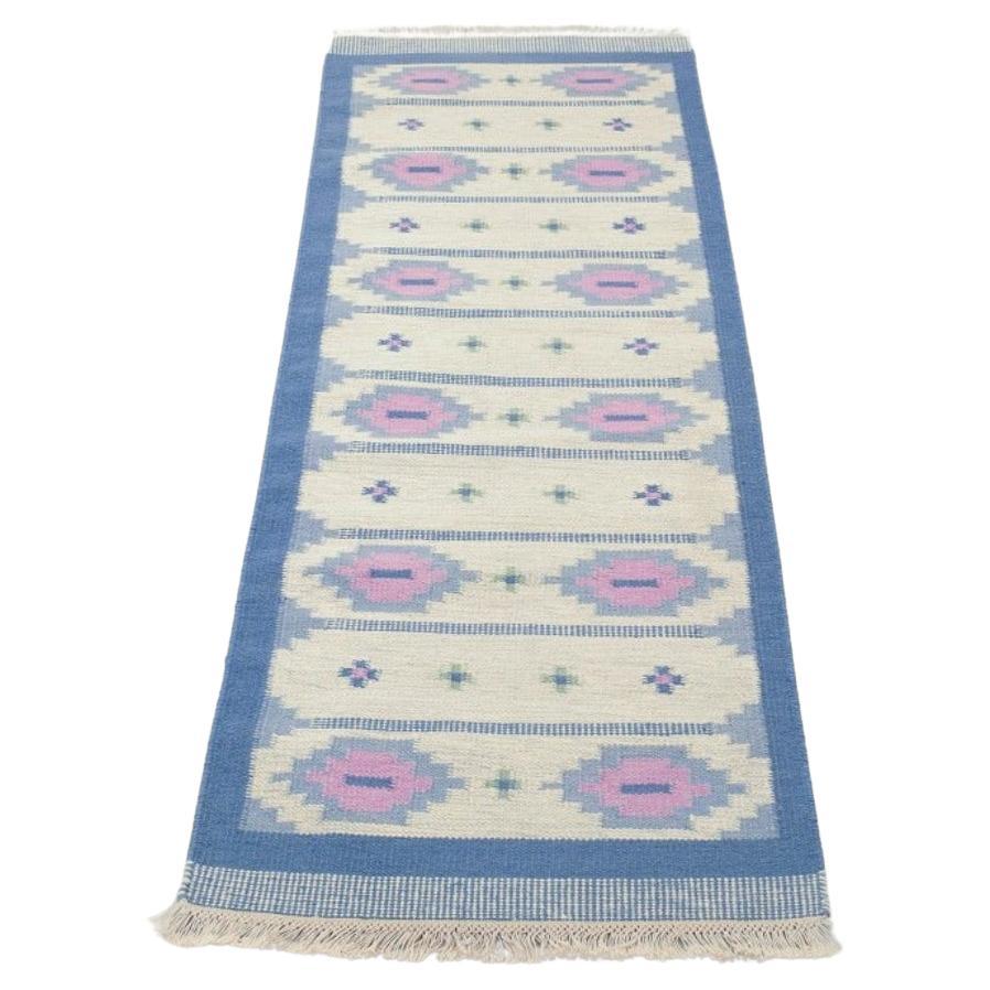 Swedish textile designer. Handwoven wool runner in blue, pink, and white colours