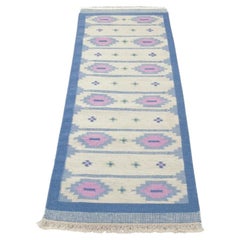 Swedish textile designer. Handwoven wool runner in blue, pink, and white colours