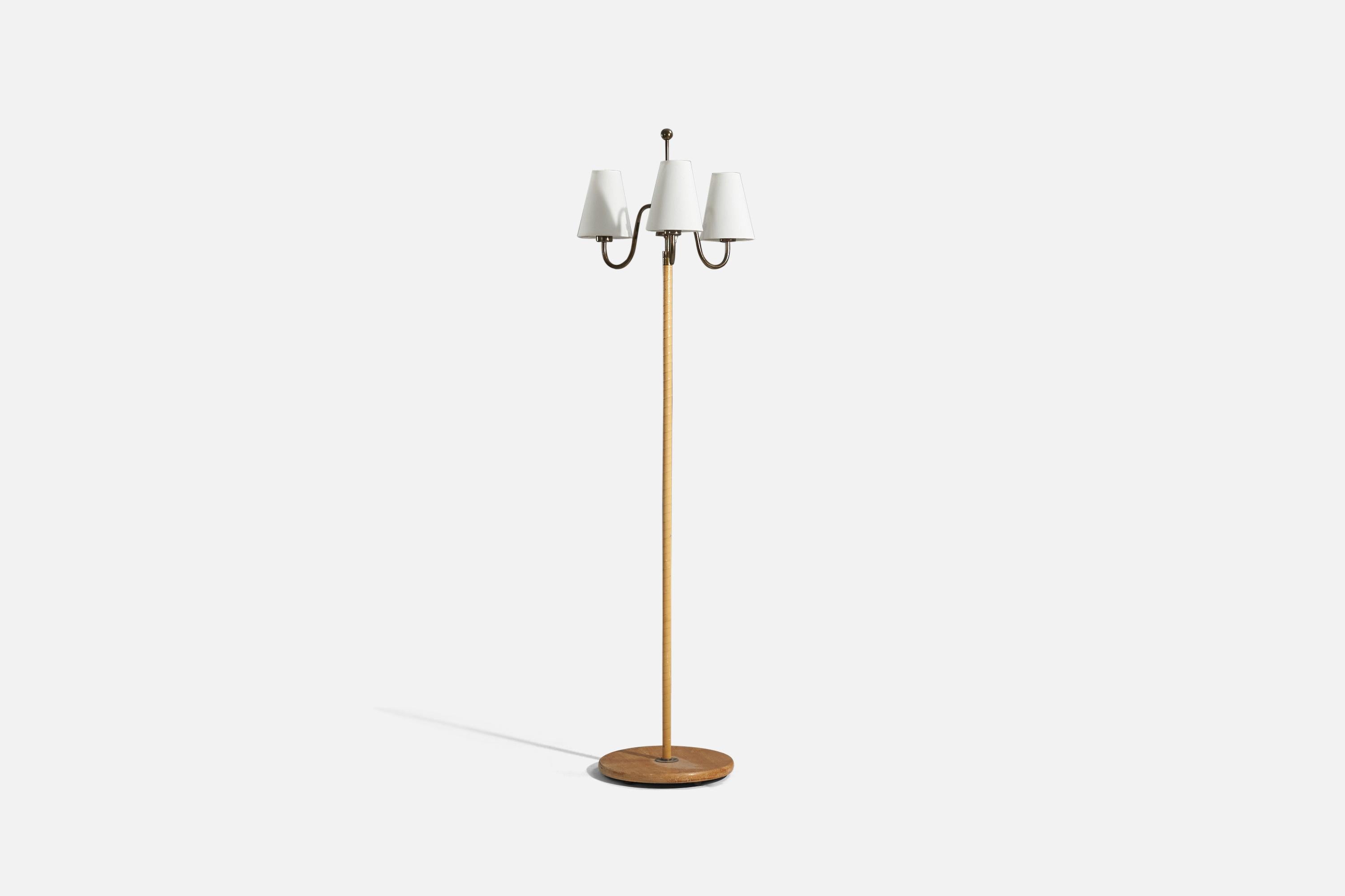 A brass, leather, oak and fabric, three-armed floor lamp designed and produced in Sweden, 1940s. 

Variable dimensions, measured as illustrated in the first image.
Sold with Lampshade(s). 
Stated dimensions refer to the Floor Lamp with the Shade(s).