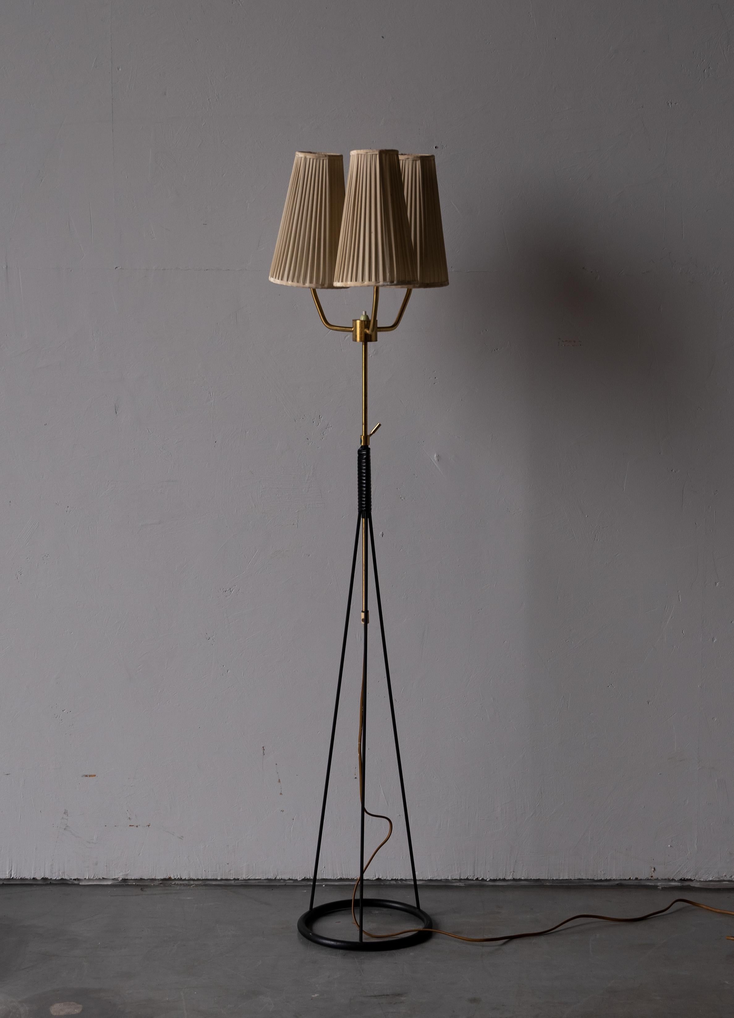 An adjustable three-armed floor lamp. In lacquered metal, brass, acrylic wrapping. Original lampshade.

Stated dimensions are measured with lampshades attached, 

Other designers of the period include Hans Bergström, Josef Frank, Paavo Tynell,