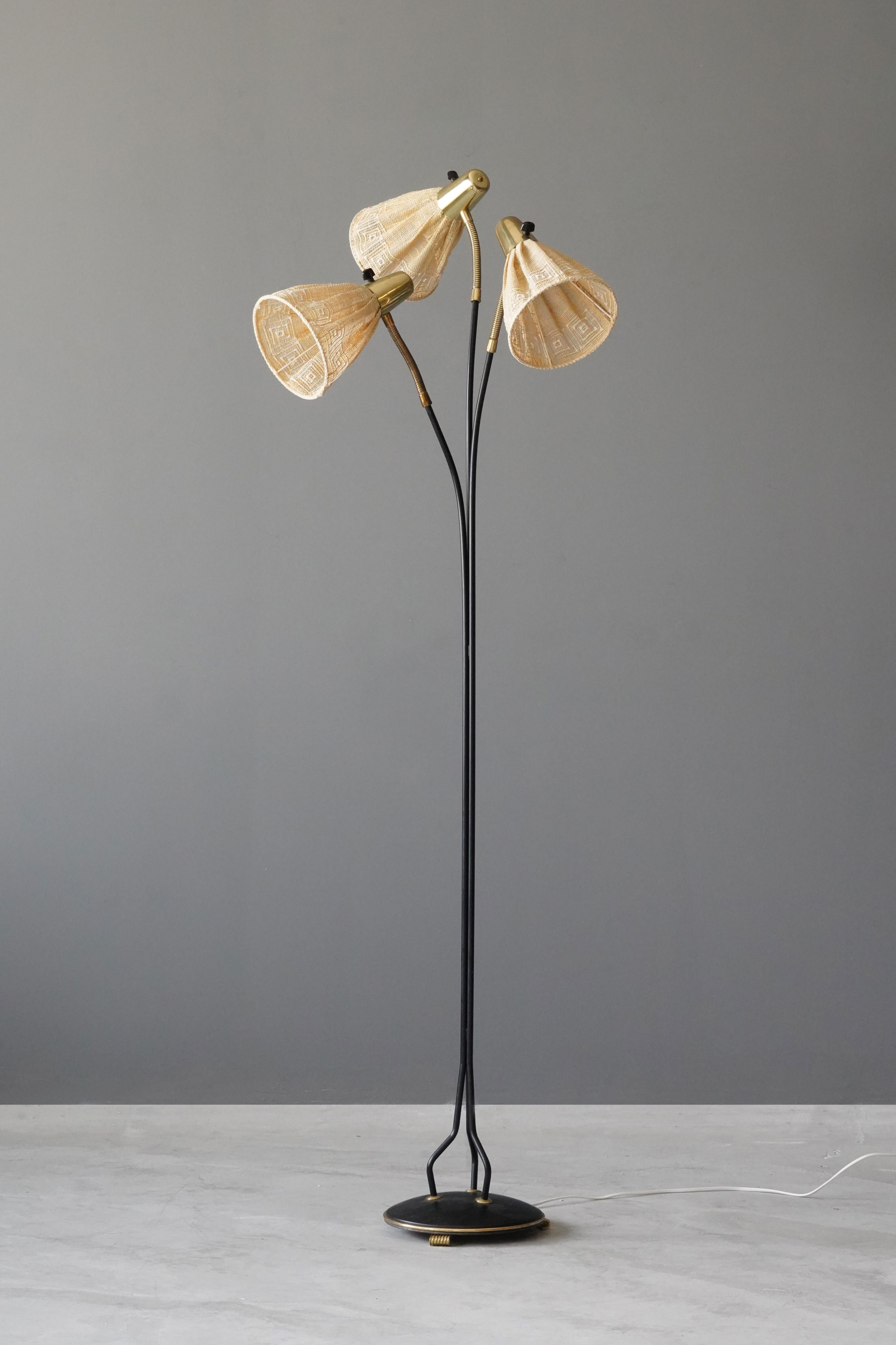 An adjustable three-armed floor lamp. In lacquered metal, brass. Original fabric lampshades.

Other designers of the period include Paavo Tynell, Hans Bergström, Hans Agne Jakobsson, Alvar Aalto, and Lisa Johansson-Pape.