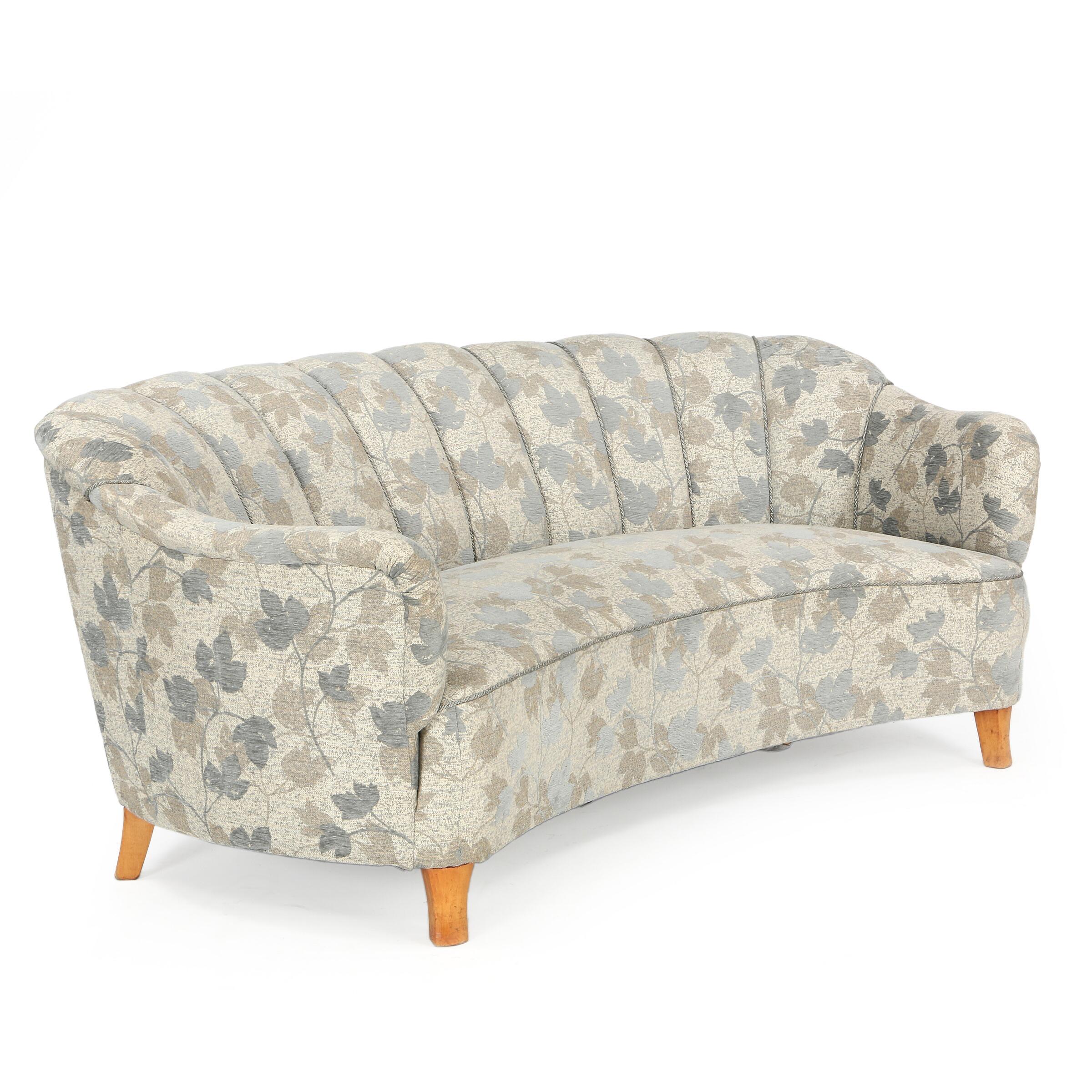 Swedish furniture design: Very comfortable and well built three-seat sofa with channelled back, legs of birch. Upholstered with flowered grey wool. Manufactured in 1940s–1950s. Measures: H 72 cm. L 188 cm. D 100 cm. There is a matching pair of