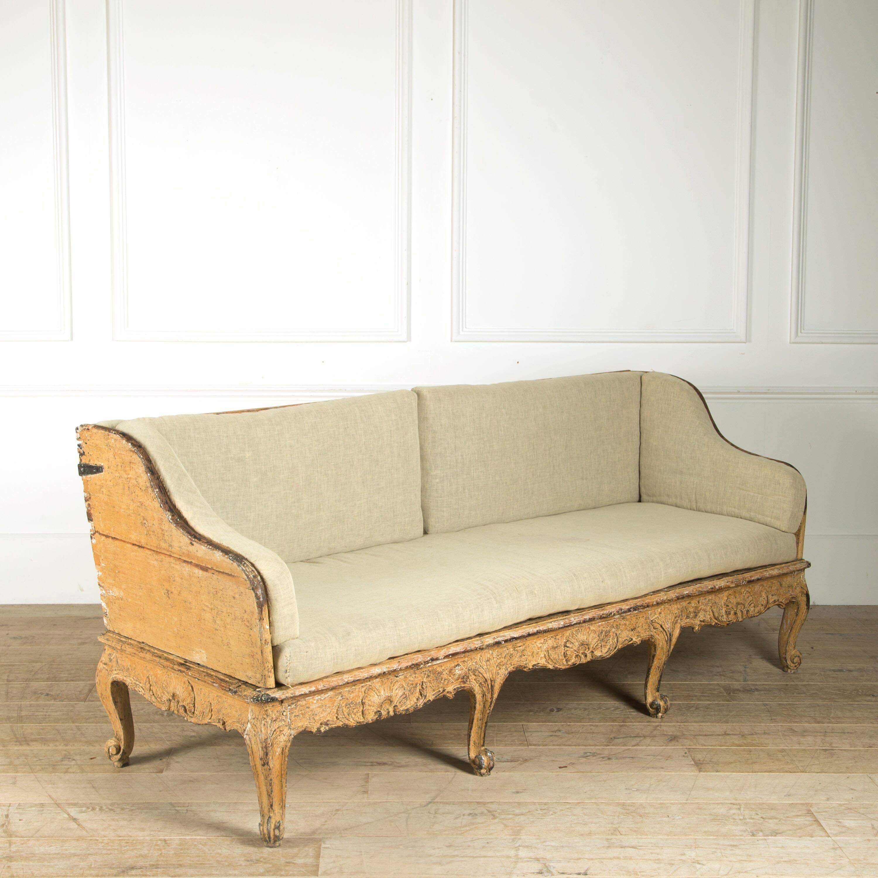 Swedish sofa manufactured in Stockholm, circa 1770.

Beautiful serpentine arms, carved ornamentation along the bottom and scroll outside legs.

The original horsehair seat pads have not been recovered. Original refreshed paint finish.