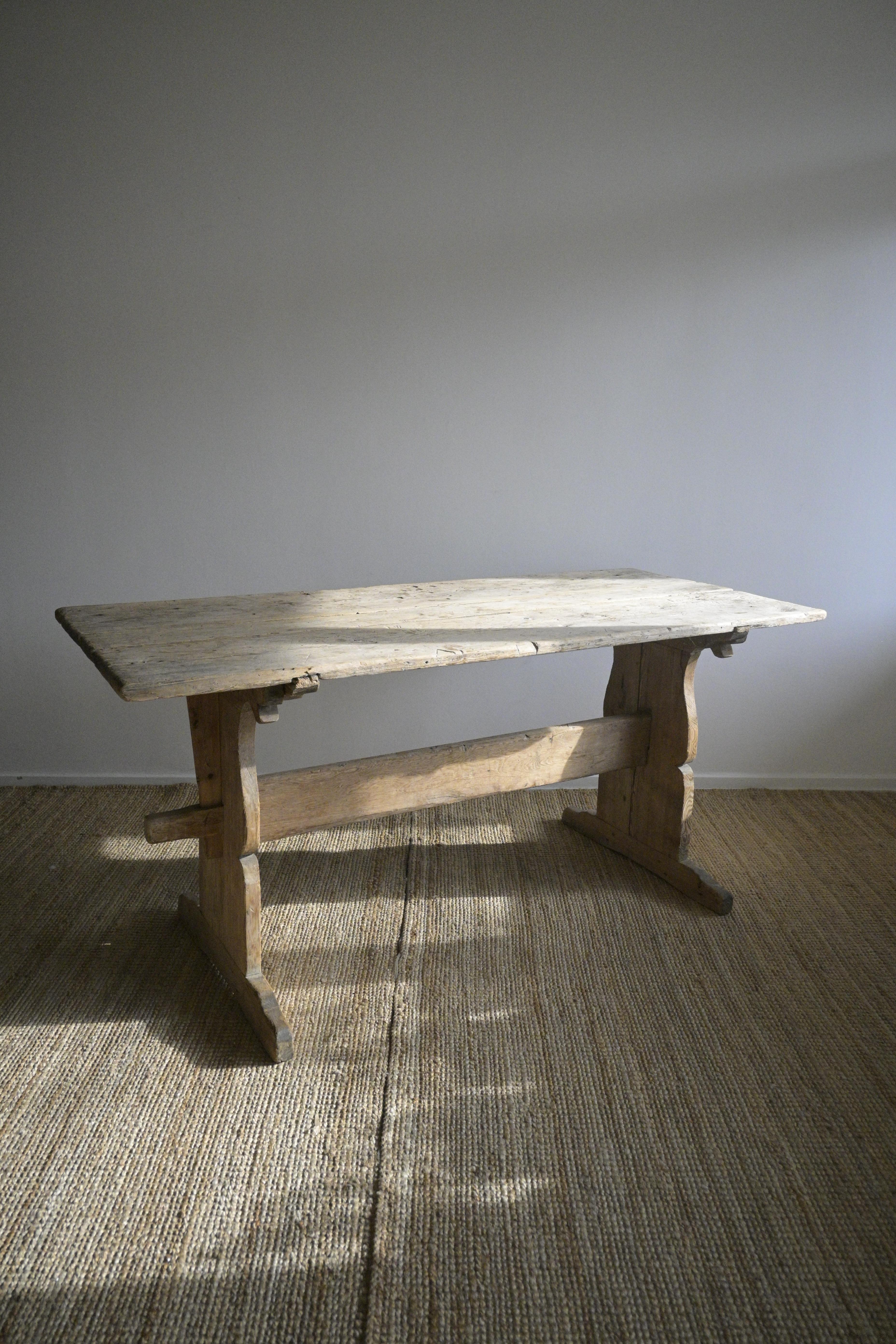 Swedish Trestle Table from Järvsö, Hälsingland, circa 1760-1780

It has markings, cracks, and letters carved into the top, to say it has a rustic feel is an understatement.

Additionally, there is a salt indentation (pit) in the corner, due to the