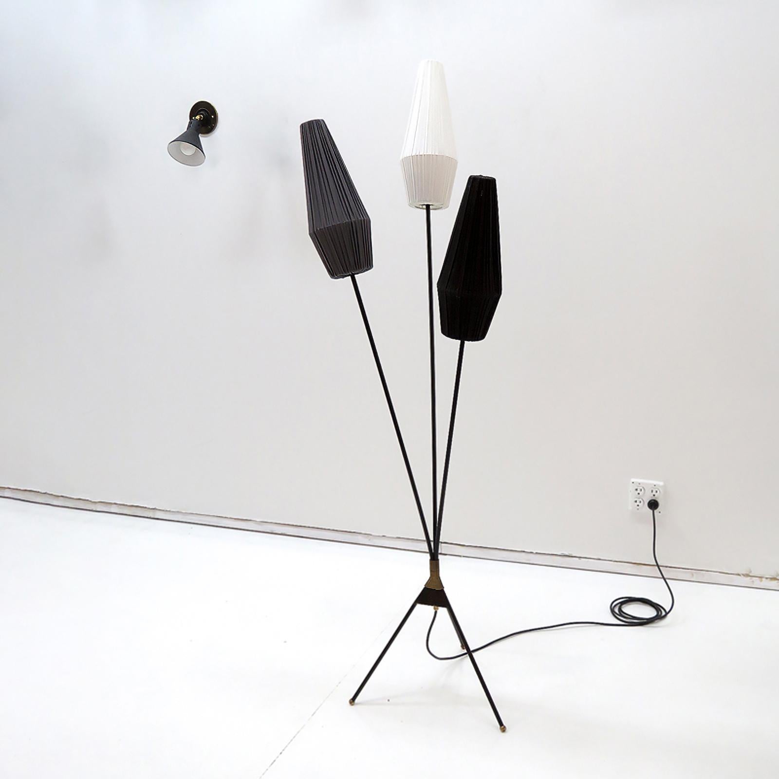 Wonderful 1950s Swedish tripod floor lamp, 1950, in black enamel with brass accents, with three tricolored fabric clip on shades, on/off switch at the convergence point of the three arm/legs, three E27 sockets, max. wattage 60w each or 3-7w LED