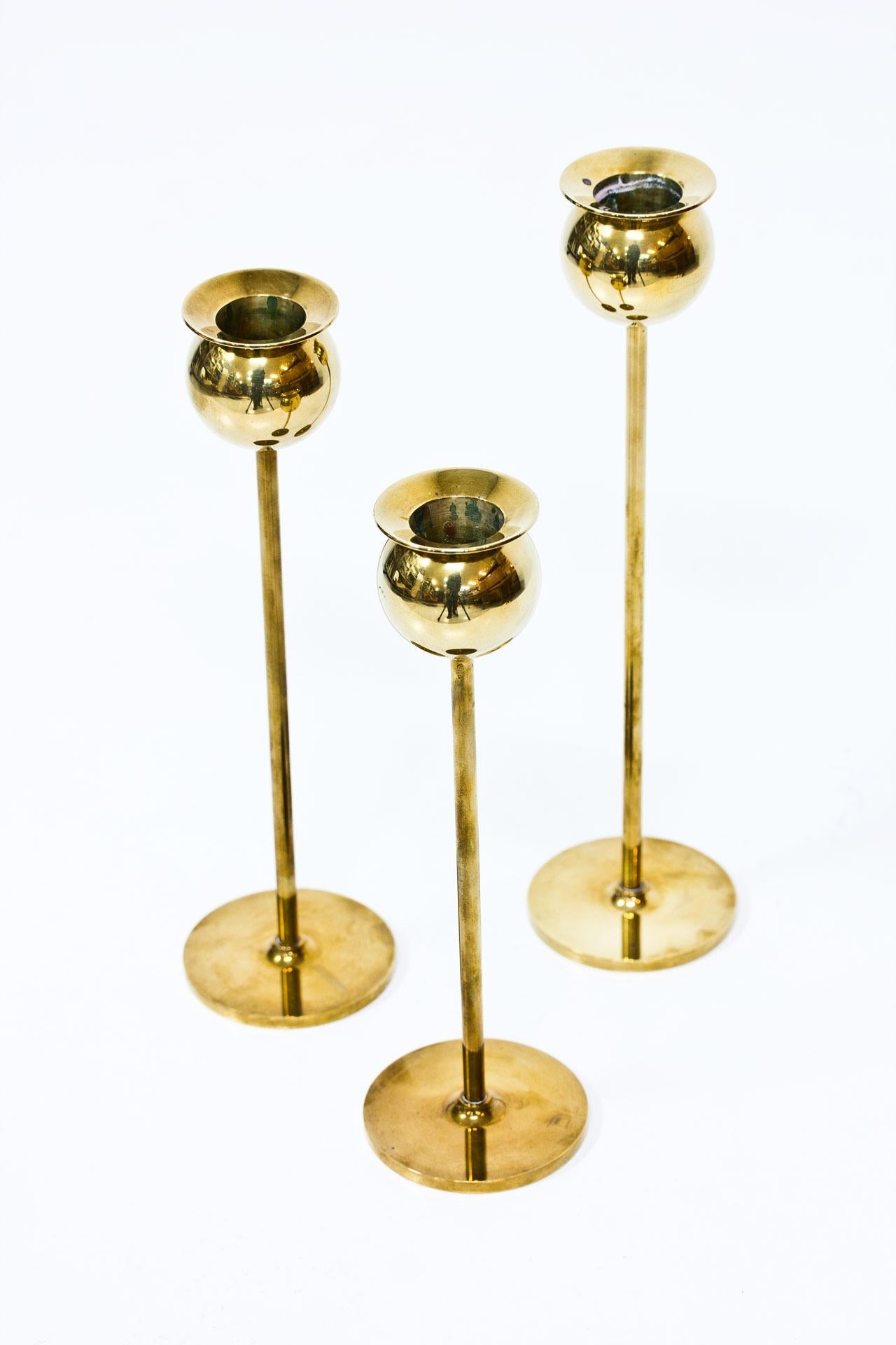Set of three brass candleholders model “Tulip” designed by Pierre Forssell for Skultuna during the 1970s. Coming with the original box. Candlesticks are engraved and bow stamped Skultuna 1607.

Height 19 to 23cm
