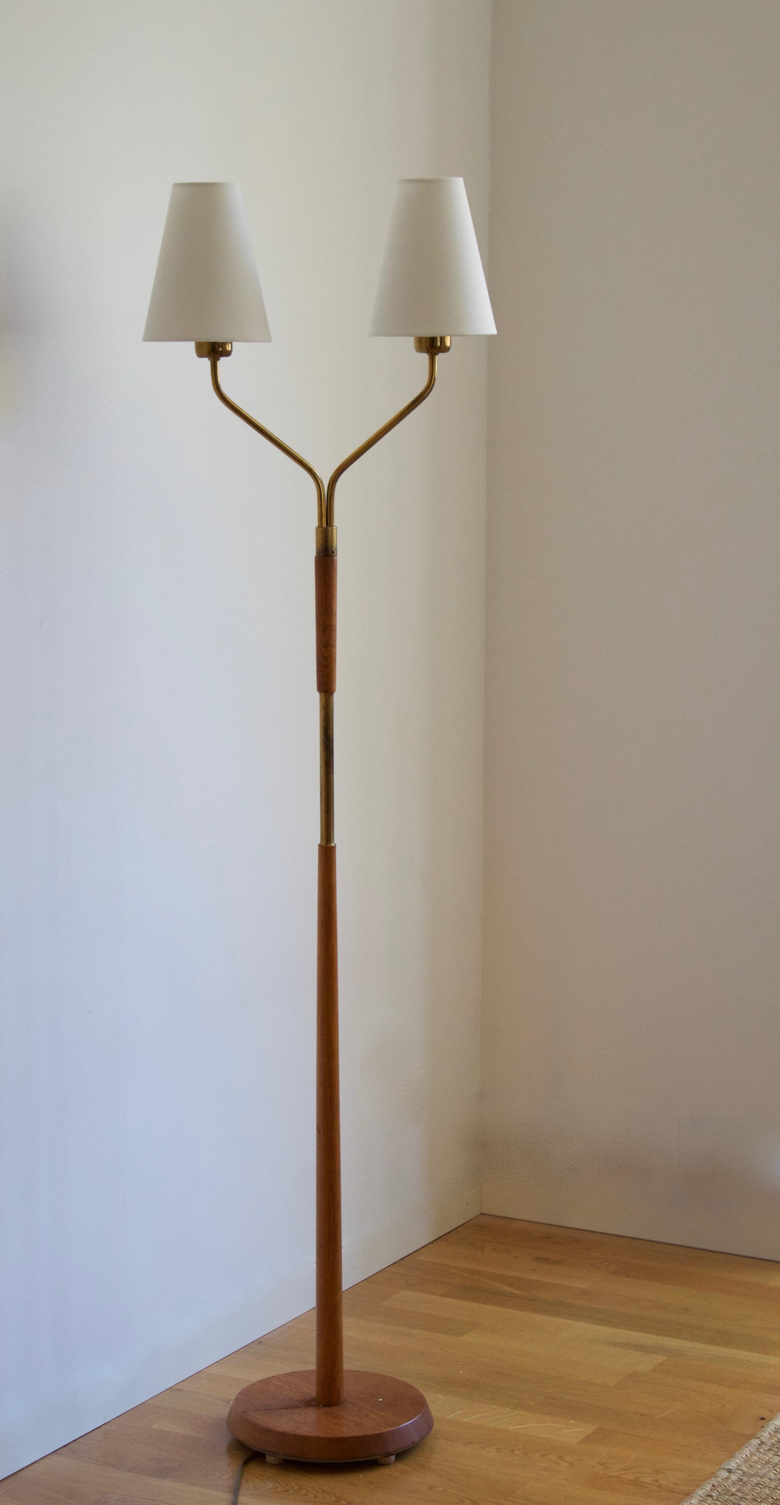 A floor lamp, designed and produced in Sweden, 1950s. In brass and teak. Brand new high-end lampshades.
 
  