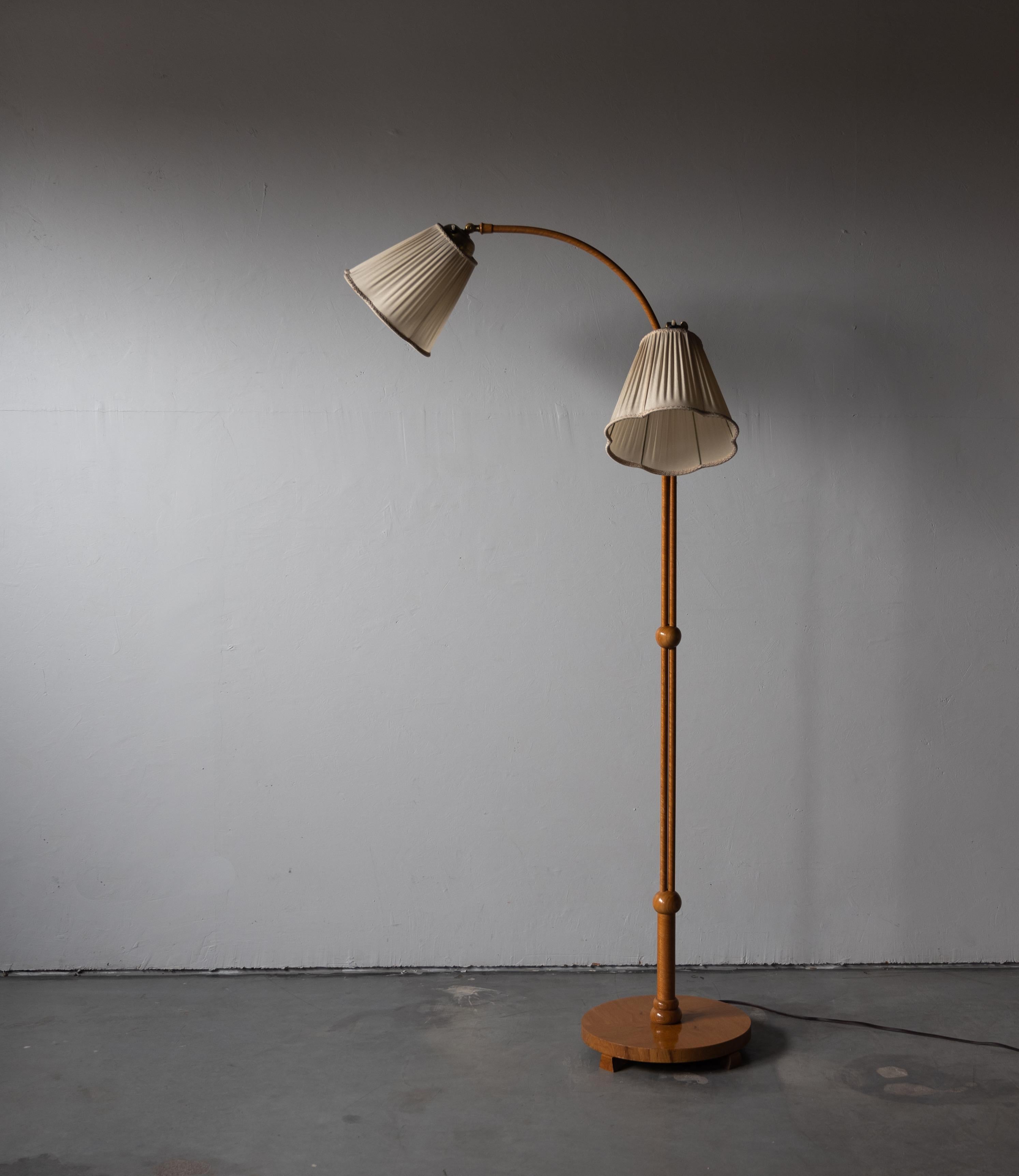 An two-armed floor lamp. Designed by an unknown Swedish designer, 1930s. Produced in wood and brass. Vintage lampshades.

Other designers working in the organic style include Jean Royère, Gio Ponti, Vladimir Kagan, Ico Parisi, and George Nakashima.